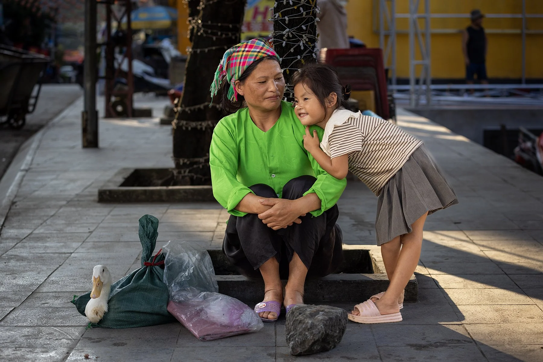 A mother and her young daughter and their duck purchased at the market in Vietnam