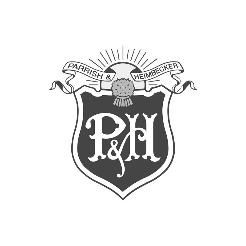 A black and white heraldic emblem with a shield featuring ornate letters 'P&H', a ribbon banner above with the words 'Parrish & Heimbecker', a round floral or wheat emblem with rays at the top center.
