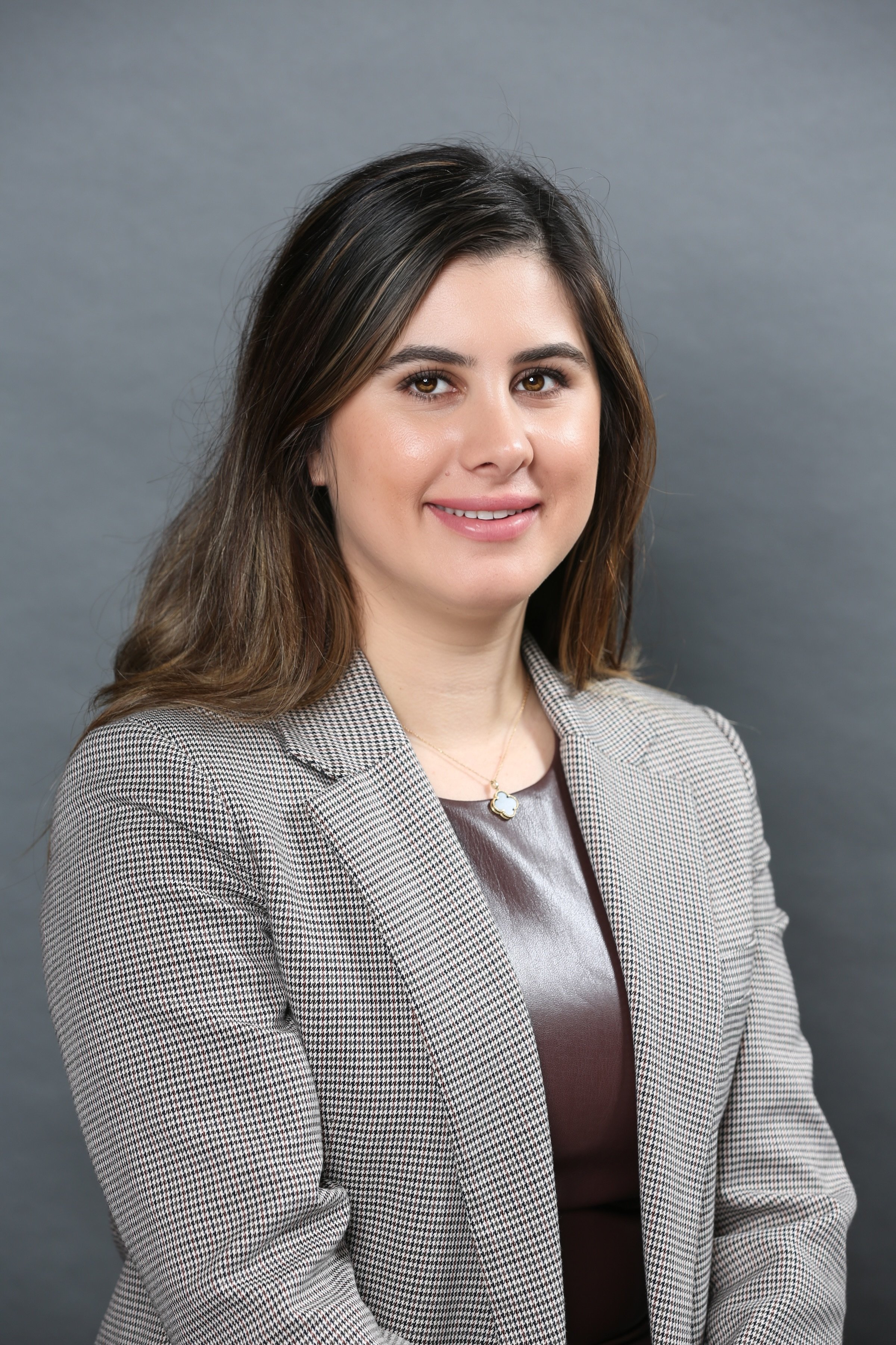 an image of Yasi Nia smiling at the camera