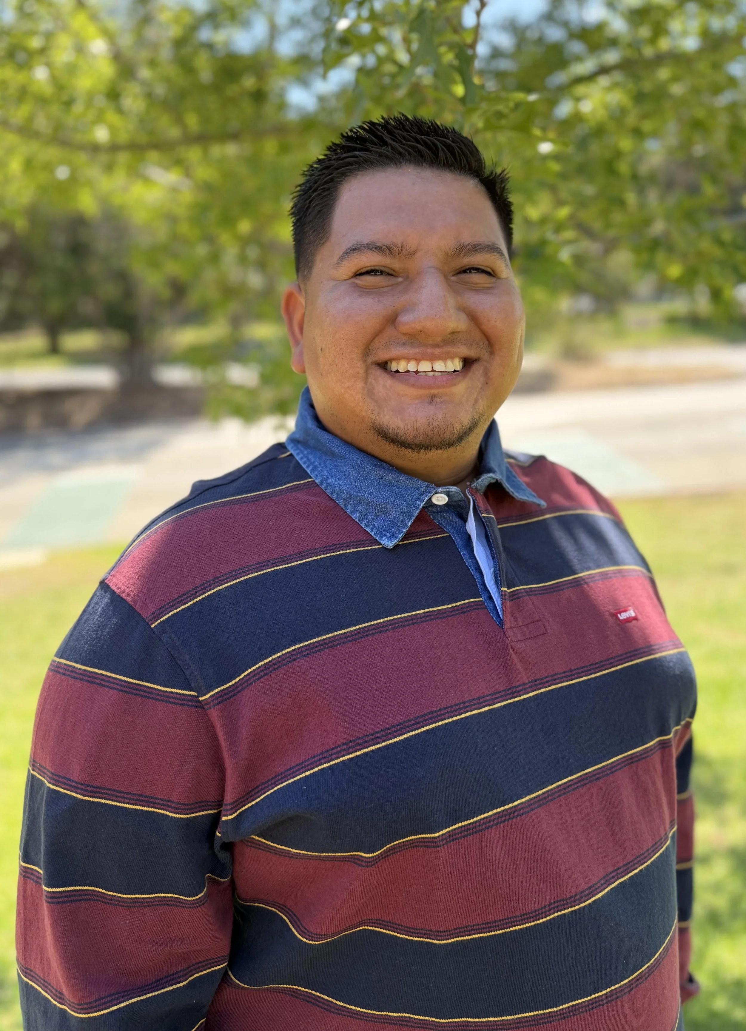 an image of Alex Xicay smiling at the camera