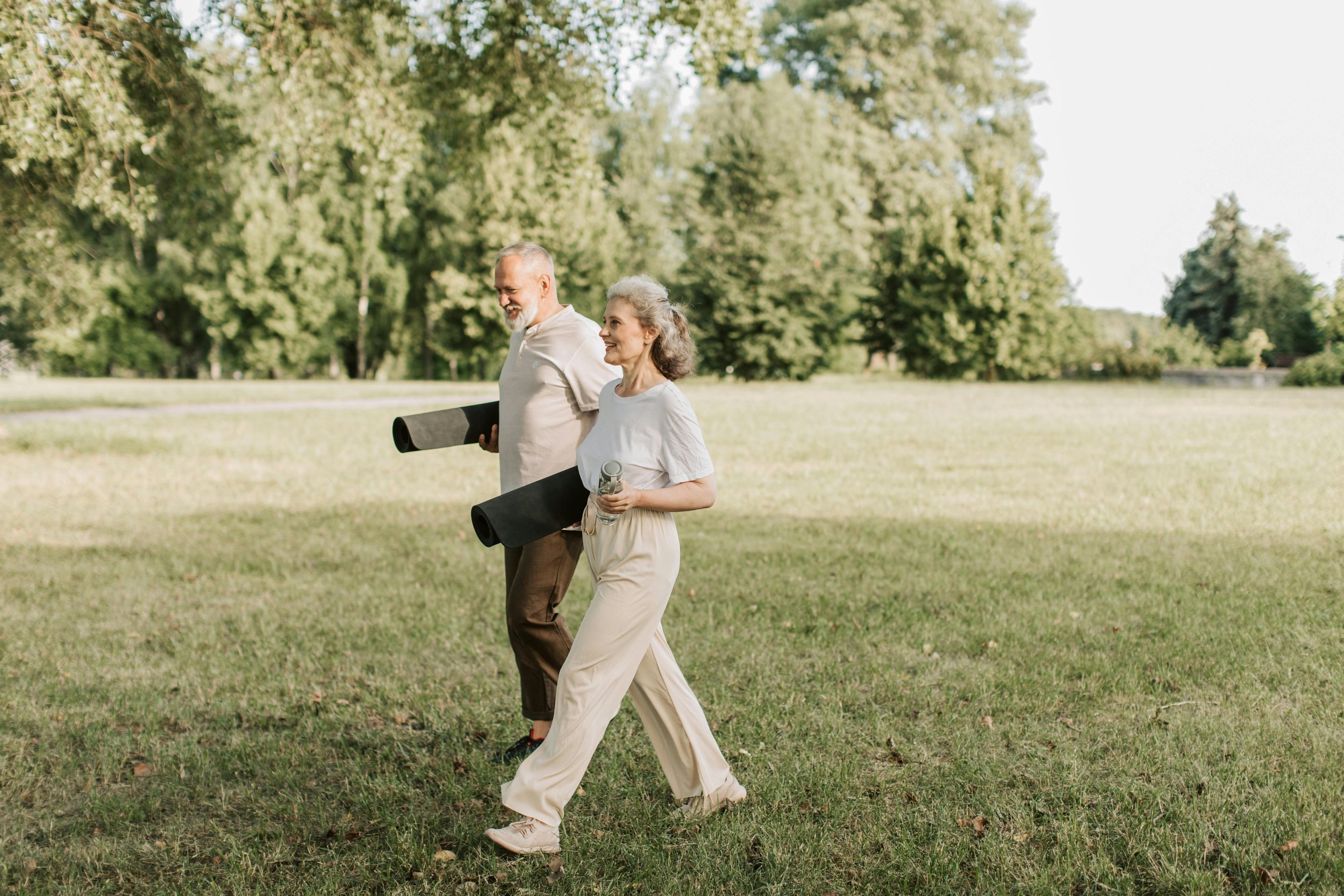 two people holding yoga mat