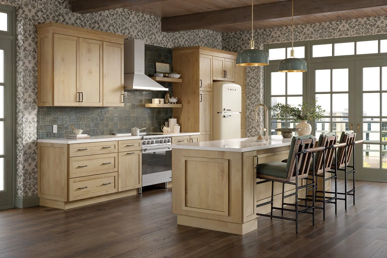 Bright kitchen with light wooden cabinets, a white countertop island with seating, a vintage refrigerator, and large windows letting in natural light.