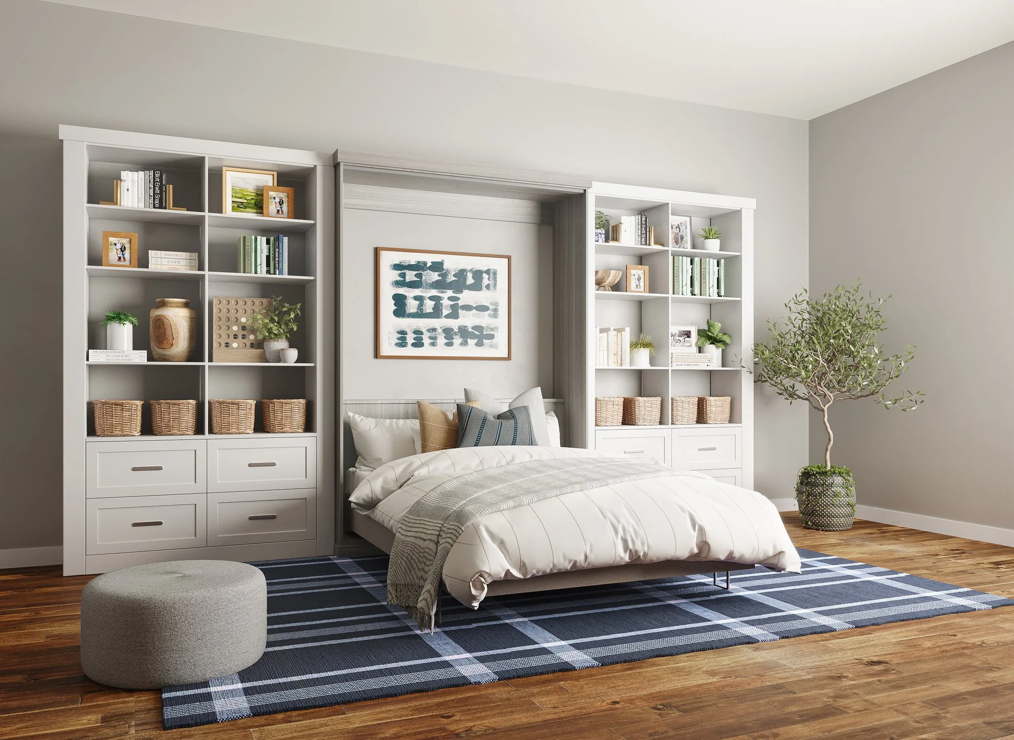 Bedroom with white murphy bed, striped bedding, and decorative pillows, surrounded by two white bookshelves with books and decor, a plaid rug, a gray ottoman, a potted tree, and framed artwork on the wall.