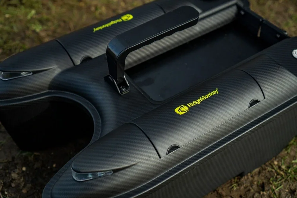 Close-up of a black, carbon-fiber hoverboard with a handle, branded RidgeMonkey, resting on the ground.