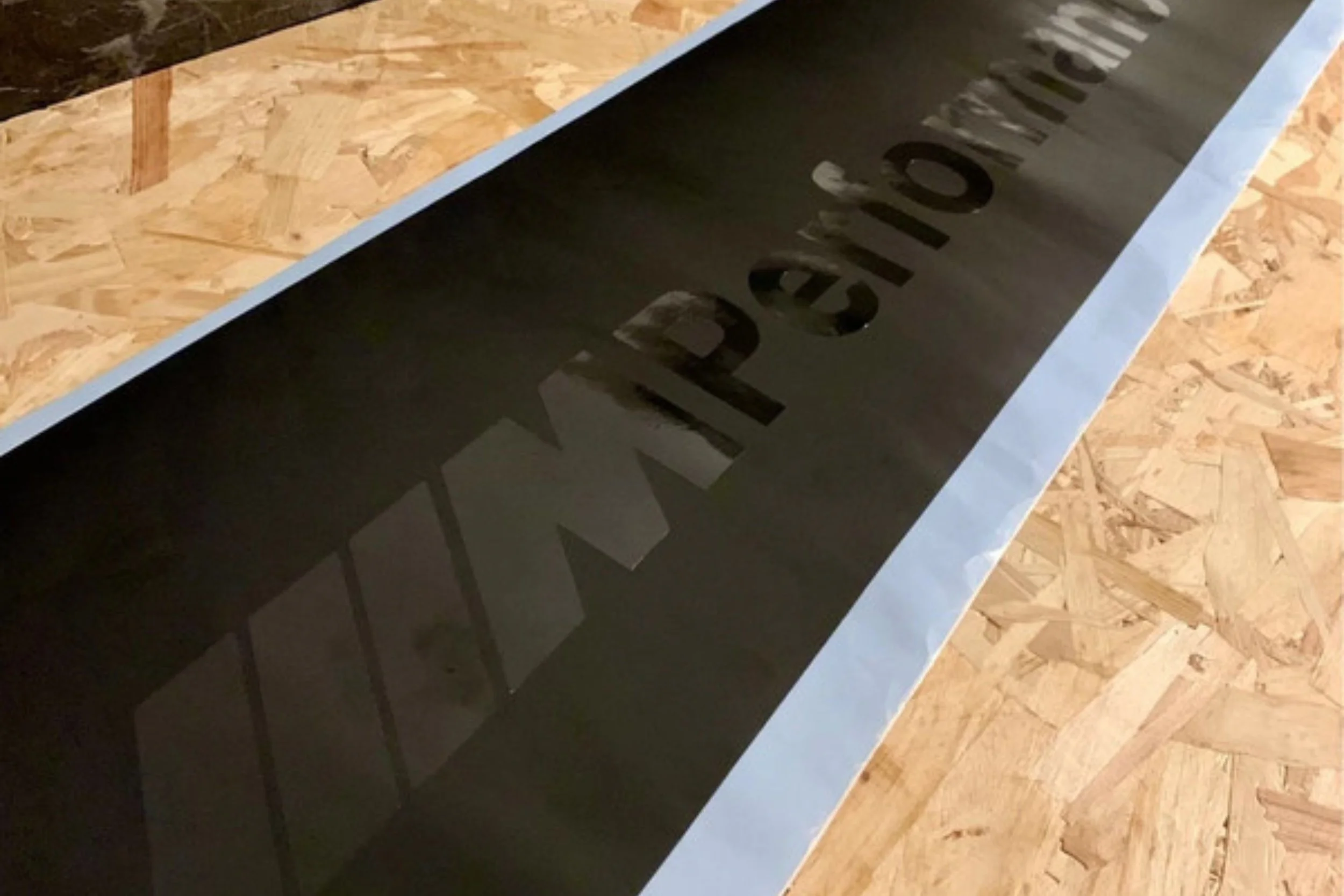 A black device with the brand name 'REVO' on it, resting on a wooden surface.