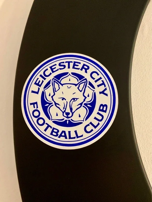 Leicester City Football Club logo sticker on a black surface.