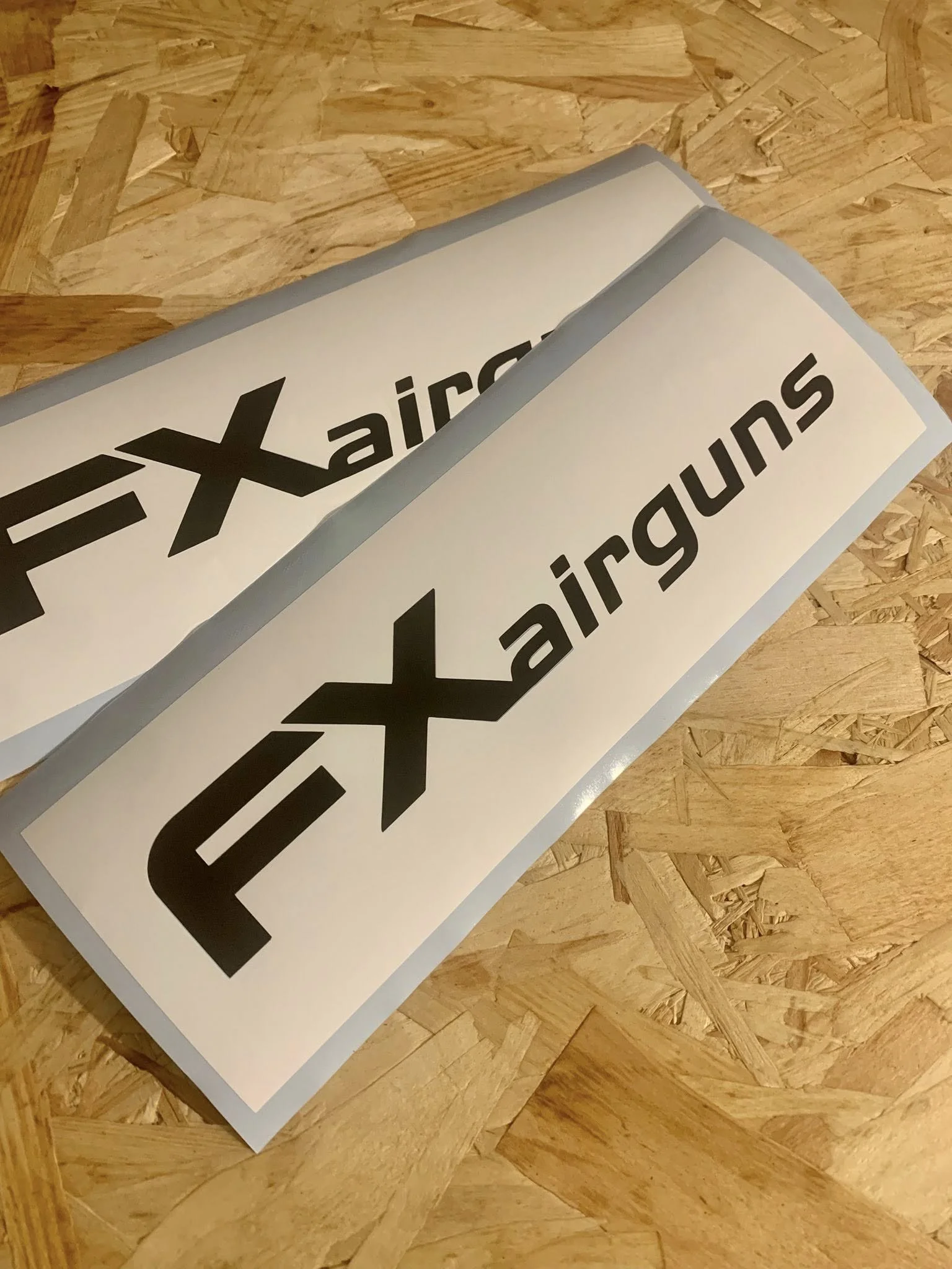 Two scratch-off tickets for the airline easa AIRLINES with a large black logo and text, lying on a wooden surface.