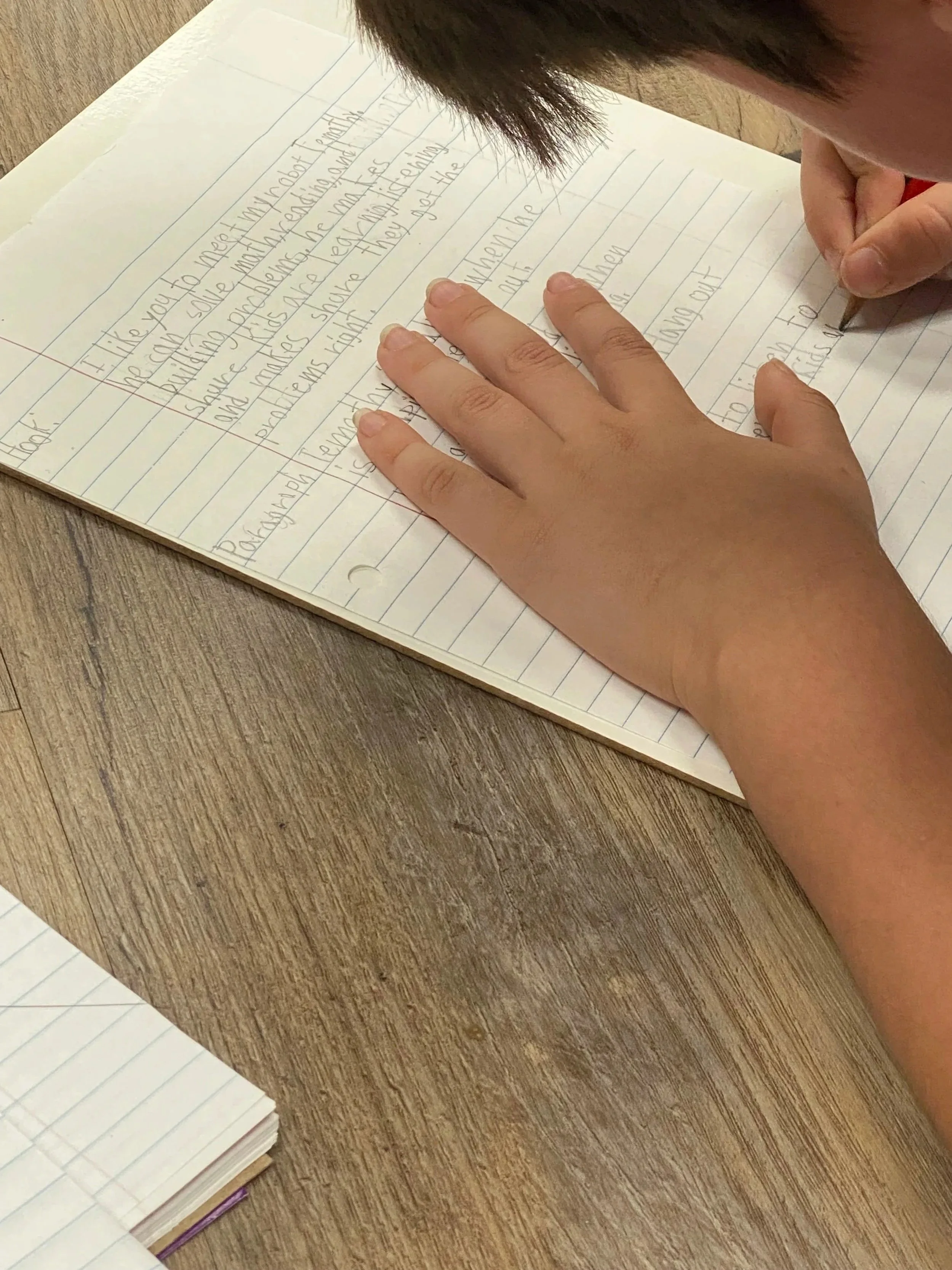 fourth grade student at House of Emet writing an essay