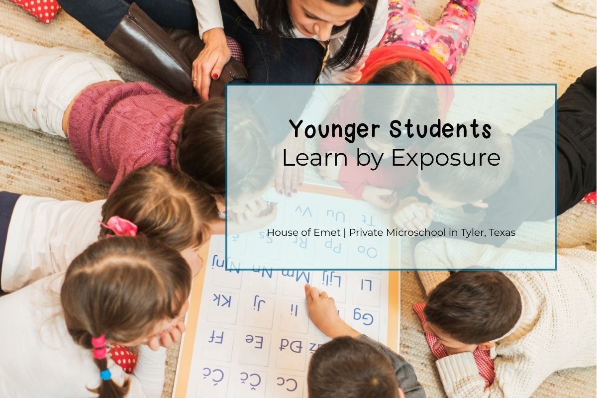 Younger students participating in a learning activity alongside older students in a multi-age classroom.