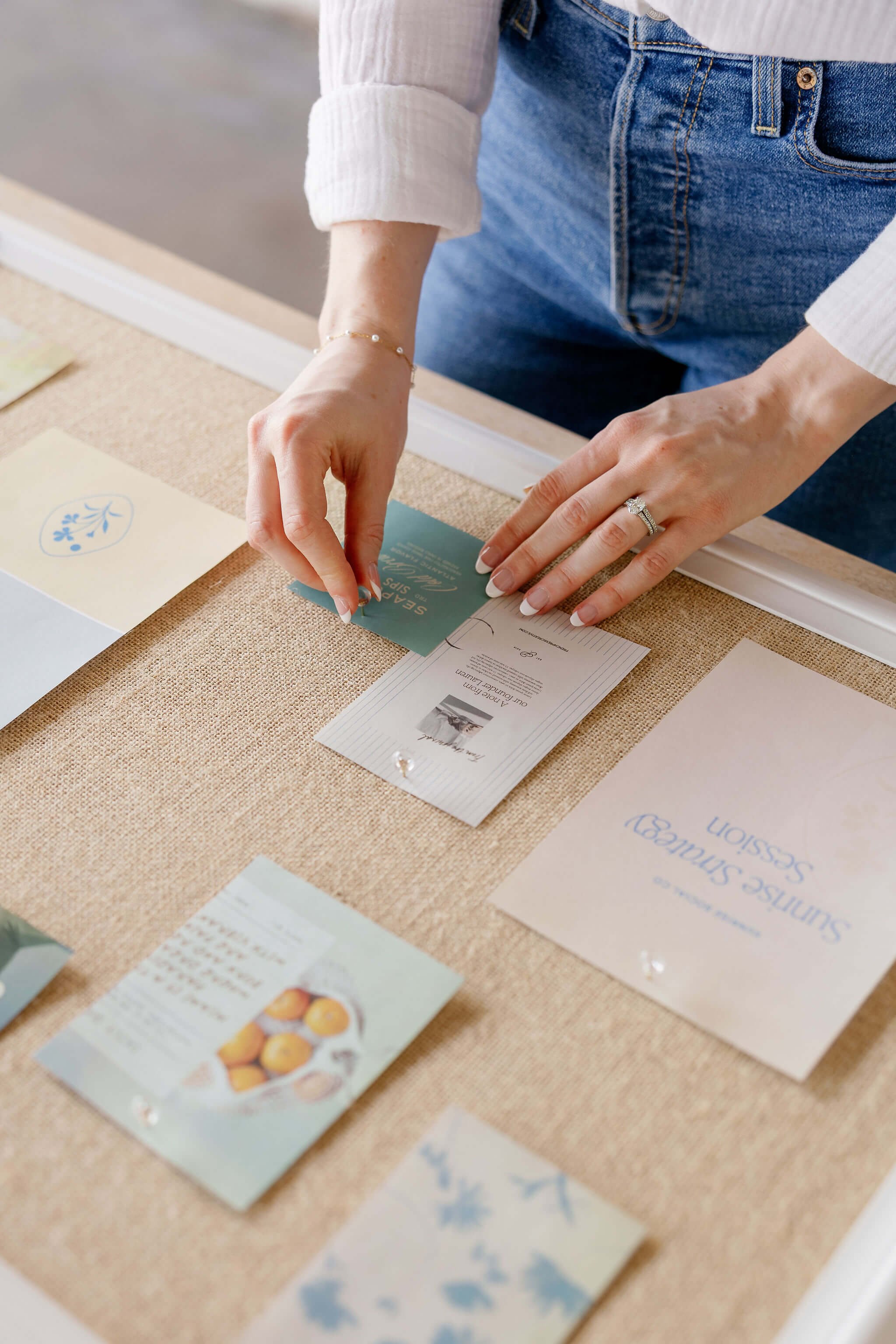 Pushing pins into a bulletin board for marketing inspiration.