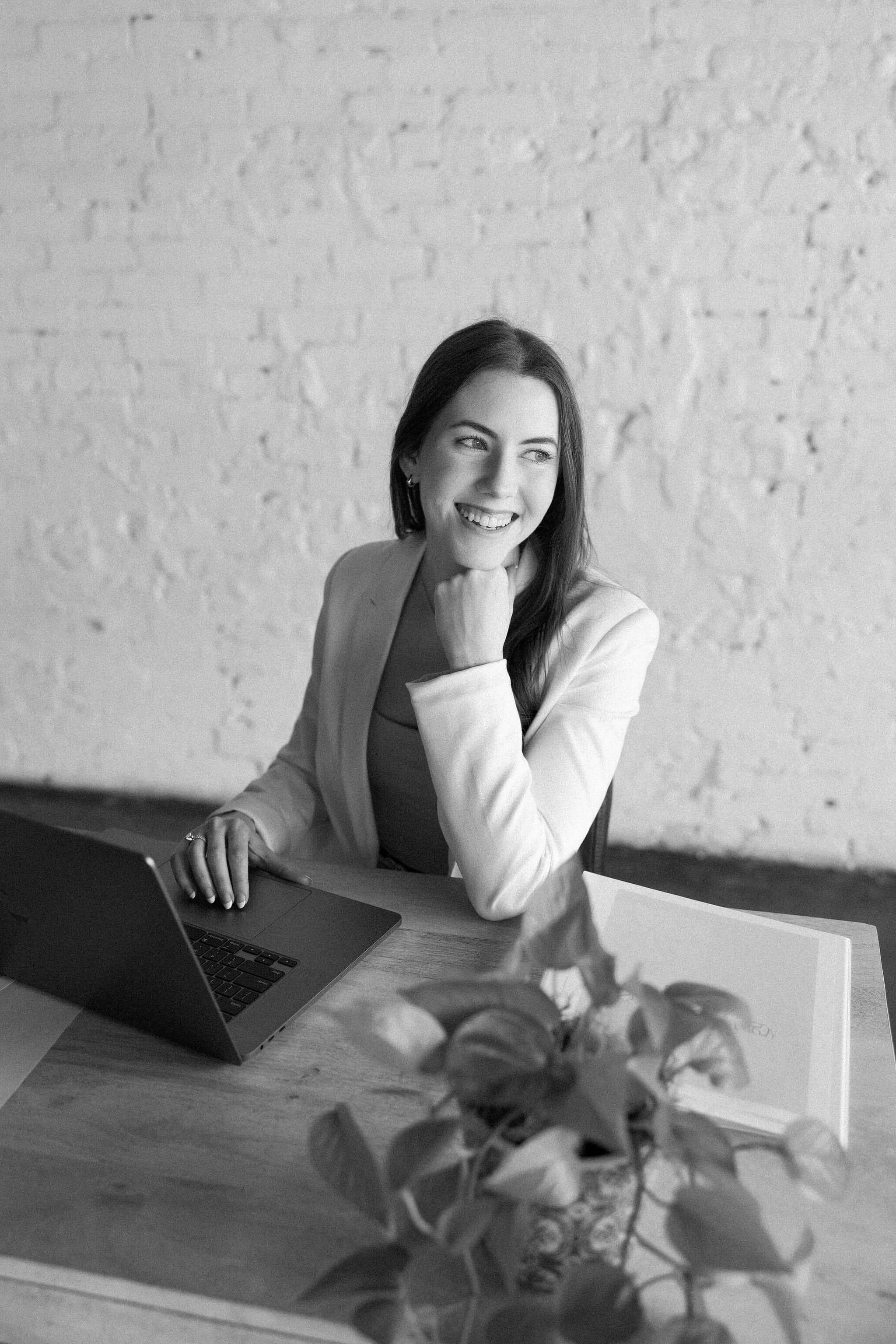A blogging manager looking off into the distance and smiling while doing work for clients.