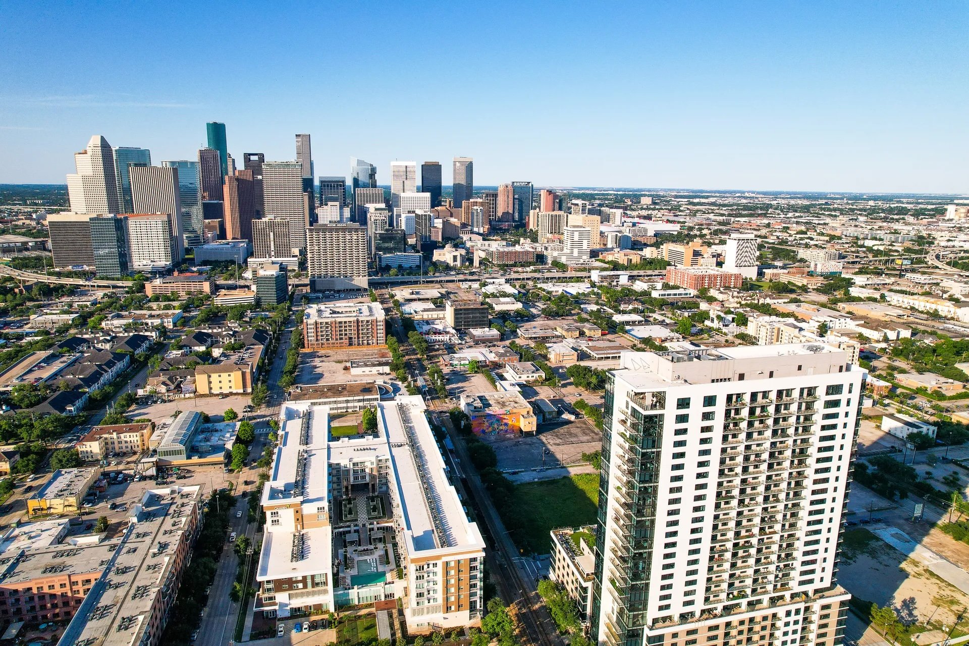 Aerial view of downtown Houston, Texas skyline with high-rise buildings and urban landscape.