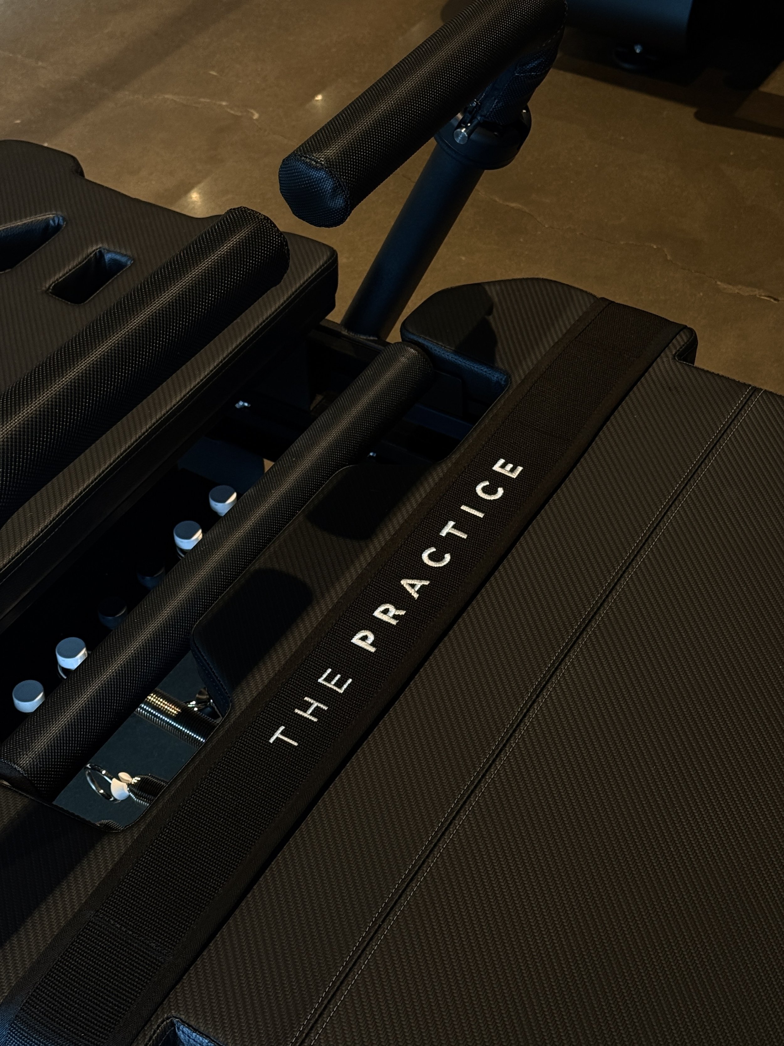 Pilates reformer-style XFormer machines arranged in a clean, modern studio