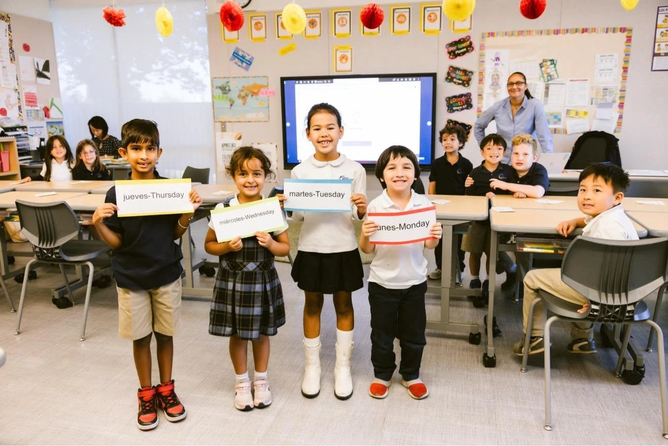 students holding activity cards in front of their class