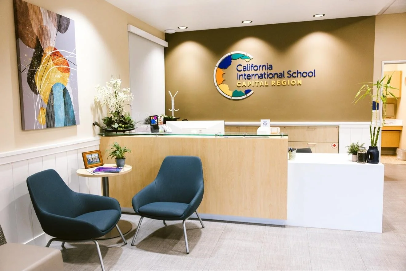School front office reception with two blue chairs