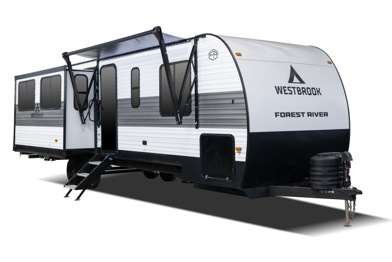 A modern travel trailer with white and black exterior, branded "Westbrook" by Forest River, featuring an extended awning, stairs, and a hitch at the front.