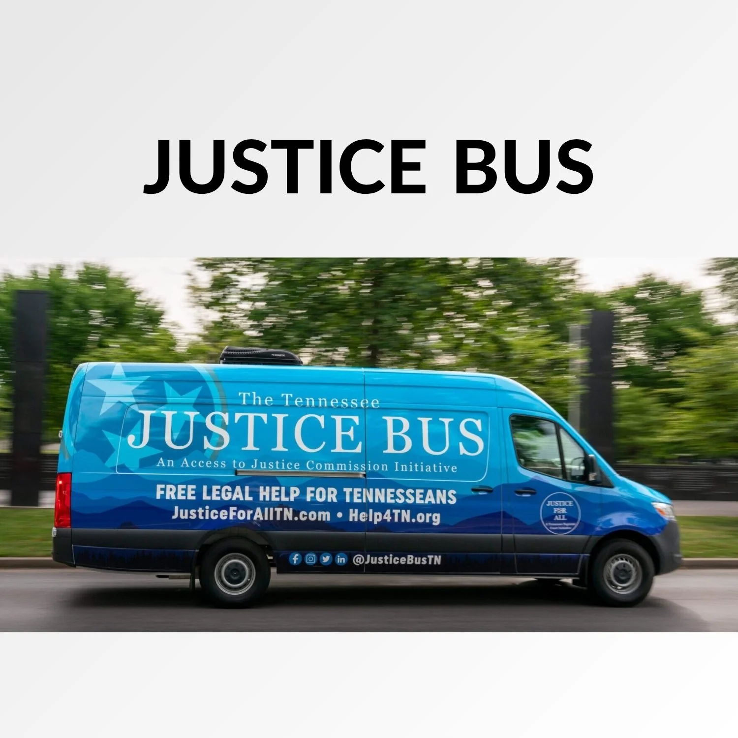 Blue Justice Bus with Tennessee and Justice for All logos, promoting free legal help for Tennesseans, driving on a road with greenery in the background.