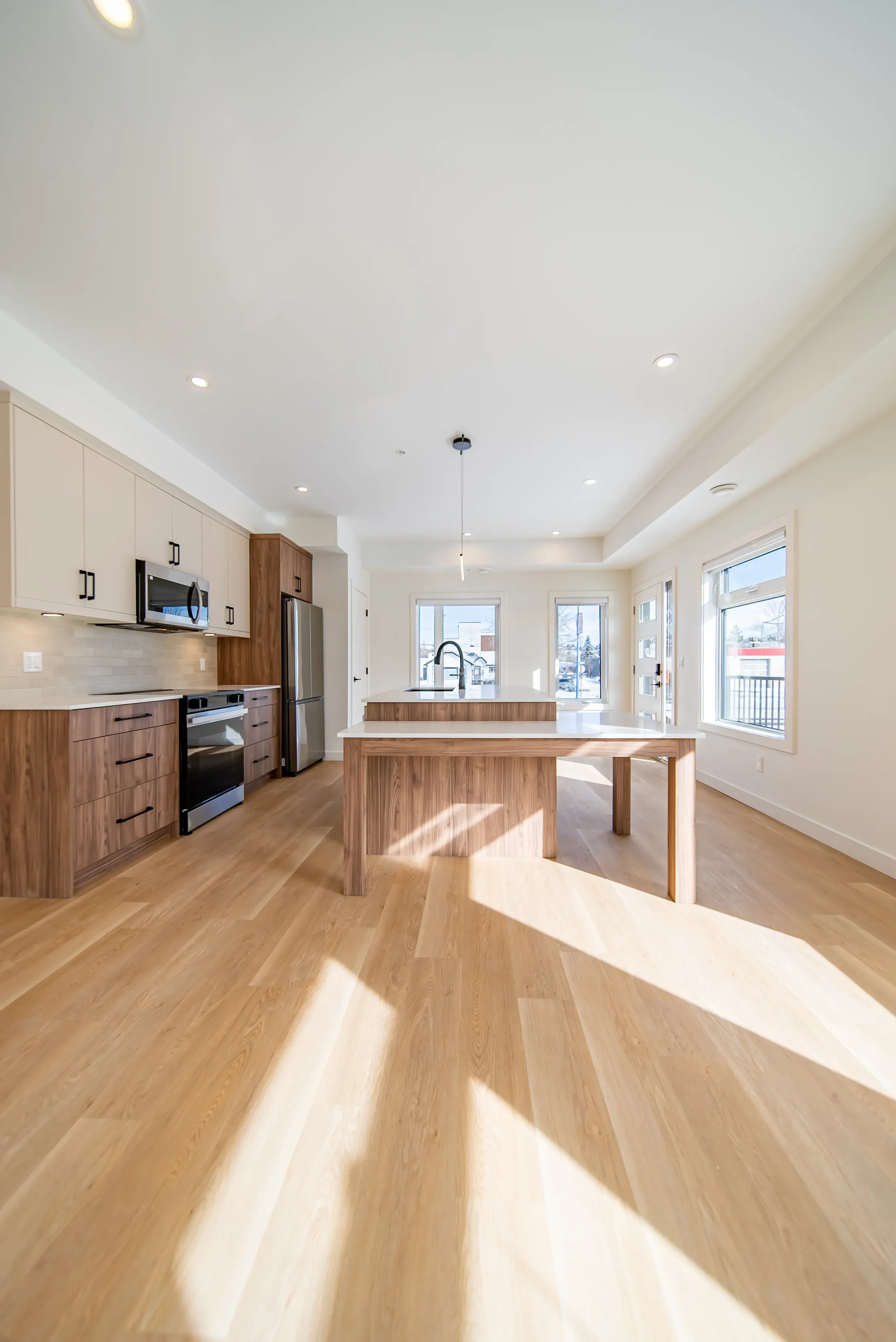 Photo of the kitchen and empty living room of a Calgary townhome