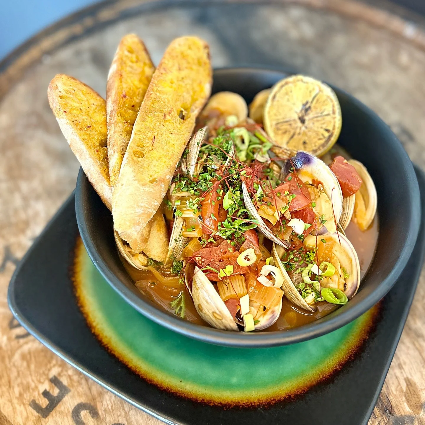Featured this evening: 
Clam Bouillabaisse:
Fresh Virginia middleneck clams cooked in a rich tomato broth with saffron and fennel.
Served with crusty baguette toasted with Rouille.
Enjoy with a @flyingmachinebrewing beer or craft cocktail. Get you