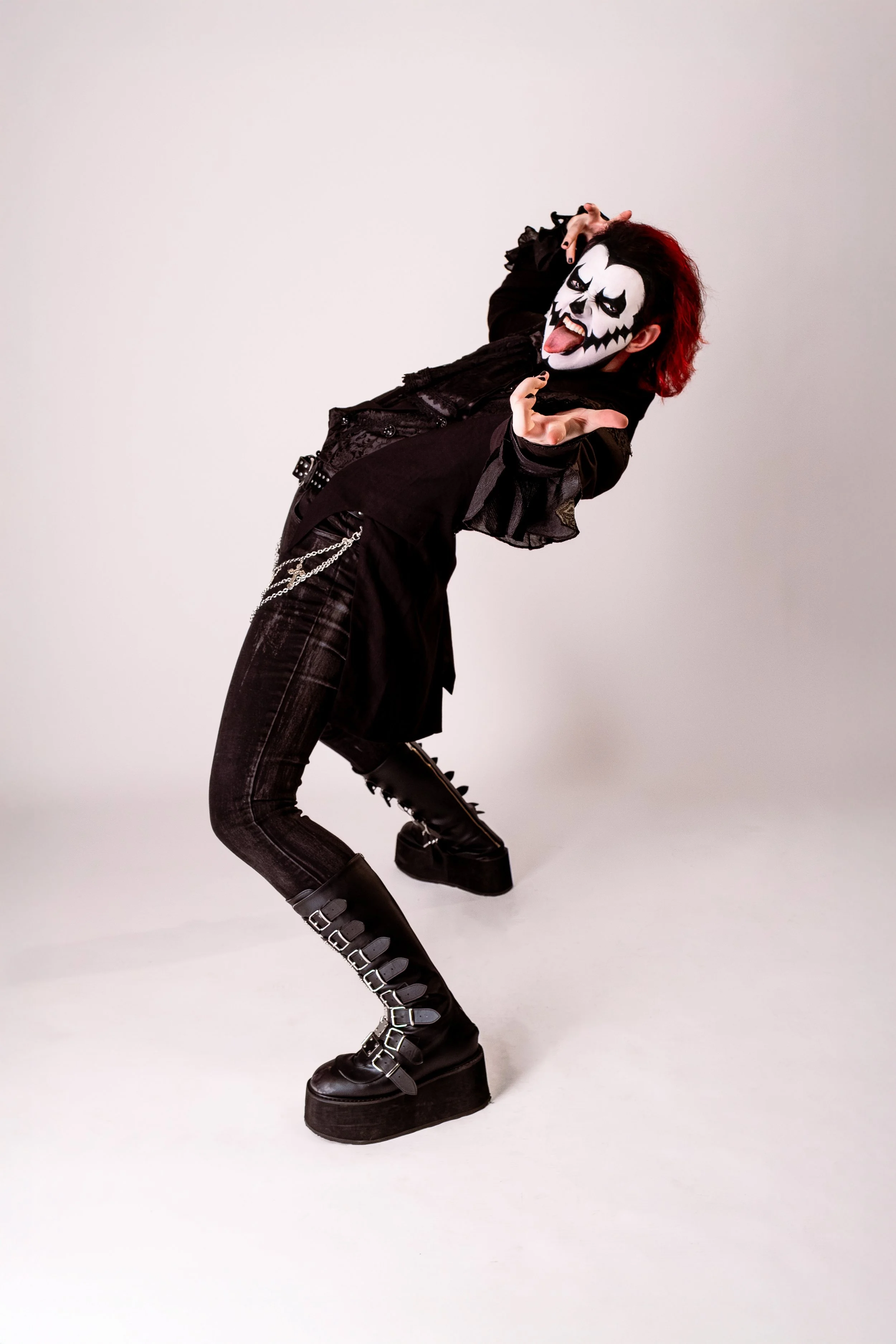 Austin Paradise in KISS-inspired black, platform boots in a dramatic pose with classic KISS make-up.