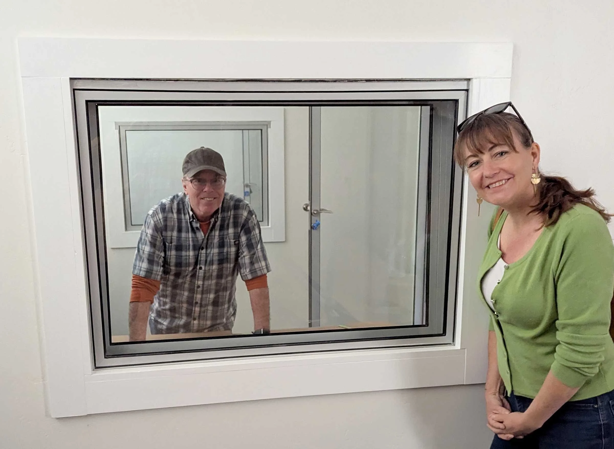 Andre and a woman show the interior windows between studios at Clay Street in Ukiah.