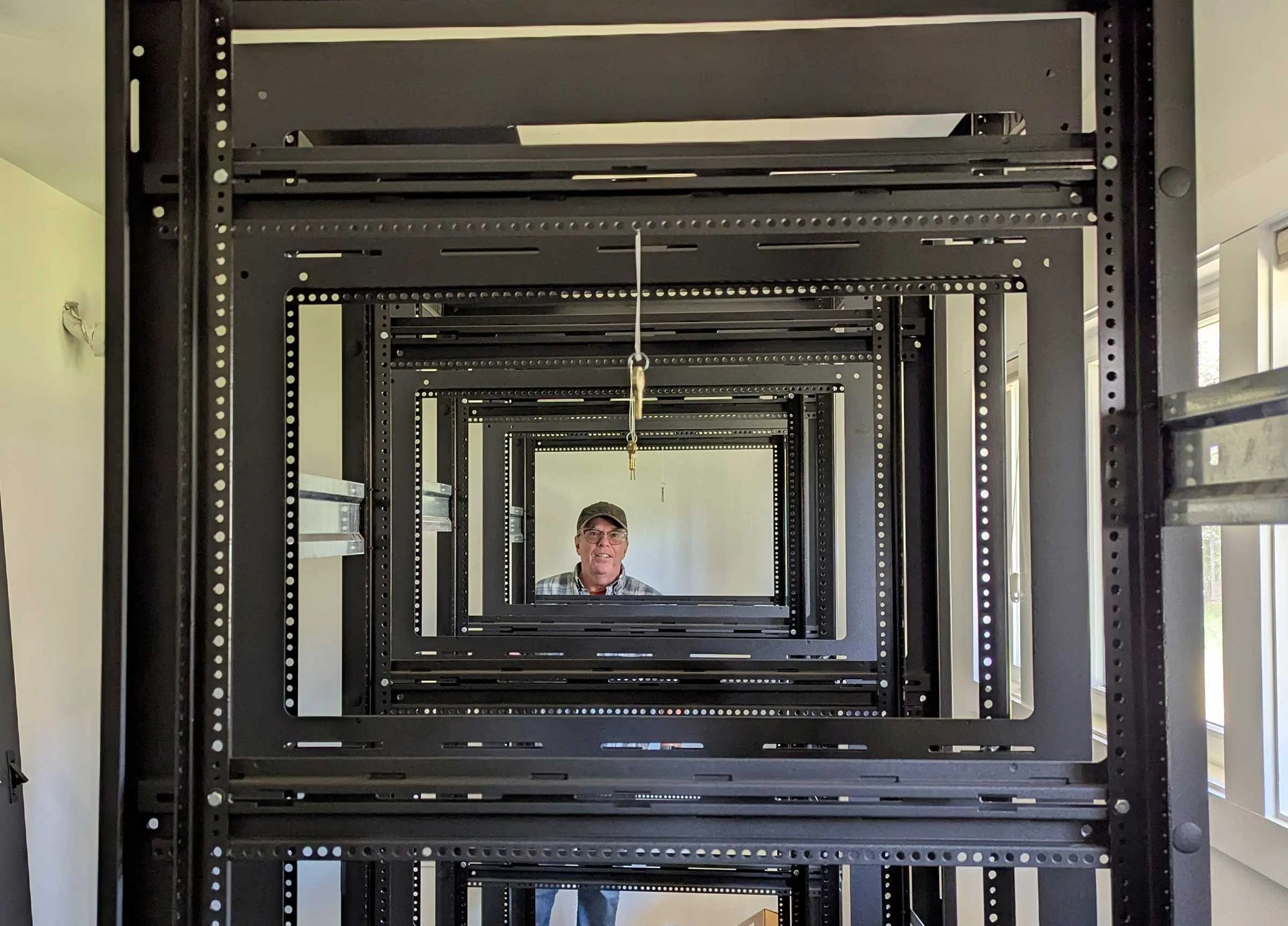 General manager Andre looks through the installed equipment racks at Clay Street KZYX new headquarters.