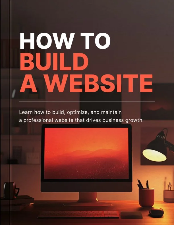 Book cover titled 'How to Build a Website' with a computer monitor, desk lamp, and stationery in a dimly lit office.