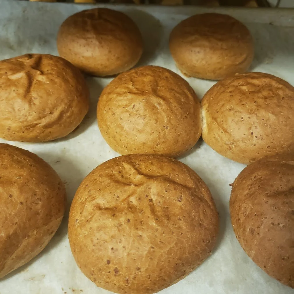 Freshly baked bread rolls on a baking sheet from Nexbakery