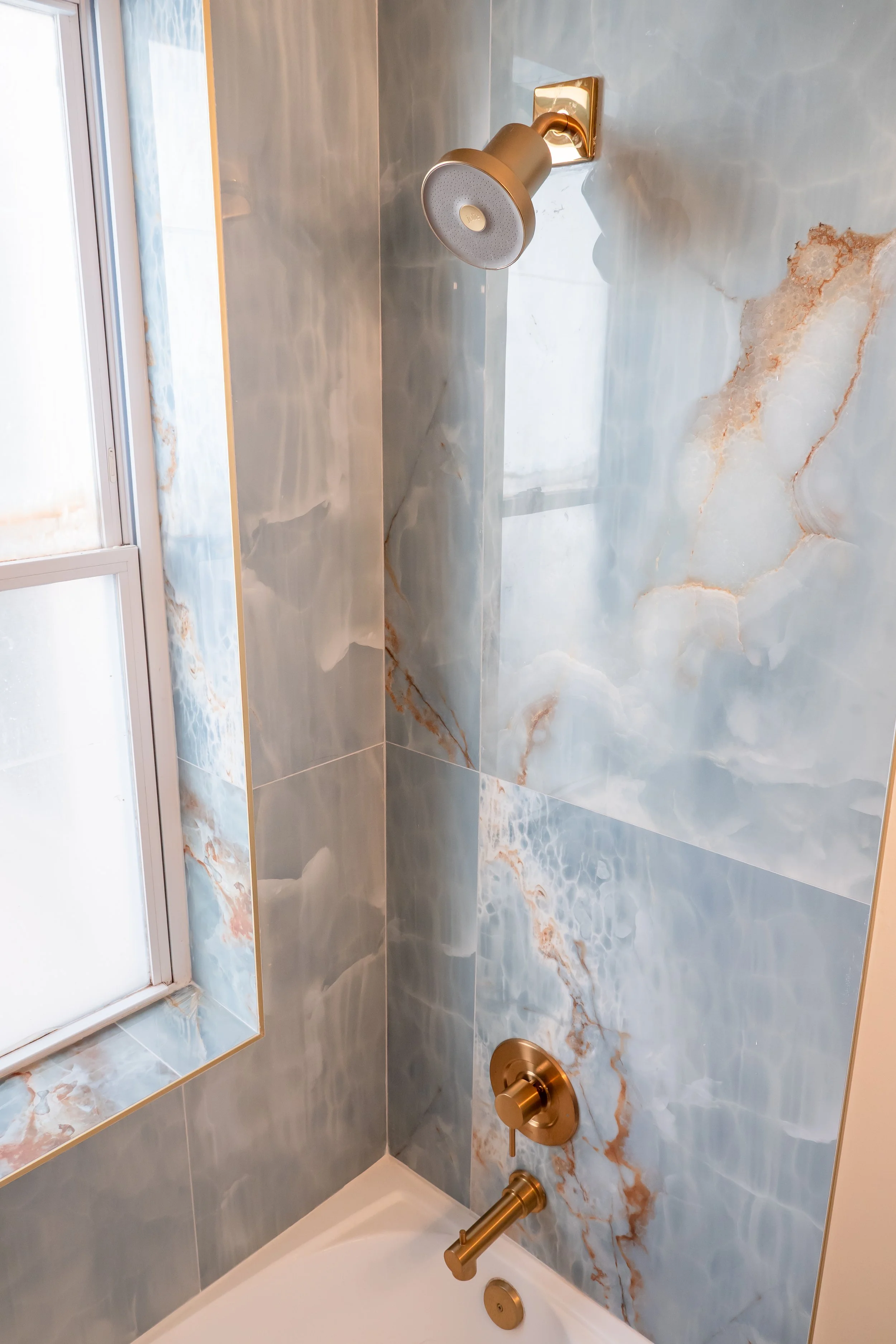 Functional built-in shower niche with precision tile work. Smart storage design for luxury bathrooms in Annapolis, MD.