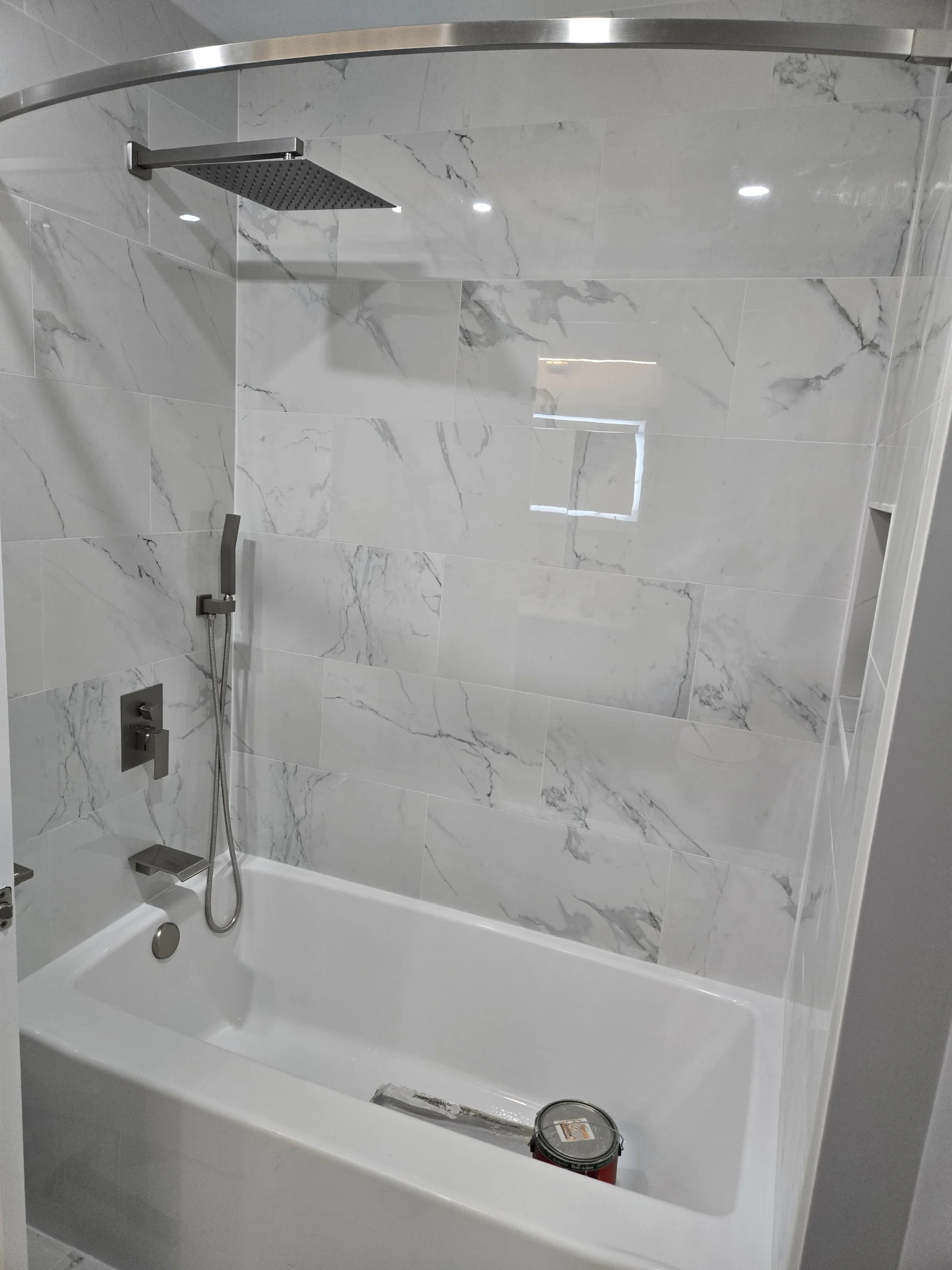 Functional recessed shower niche with custom tile detail. Smart storage solutions for modern bathroom renovations in Long Branch.