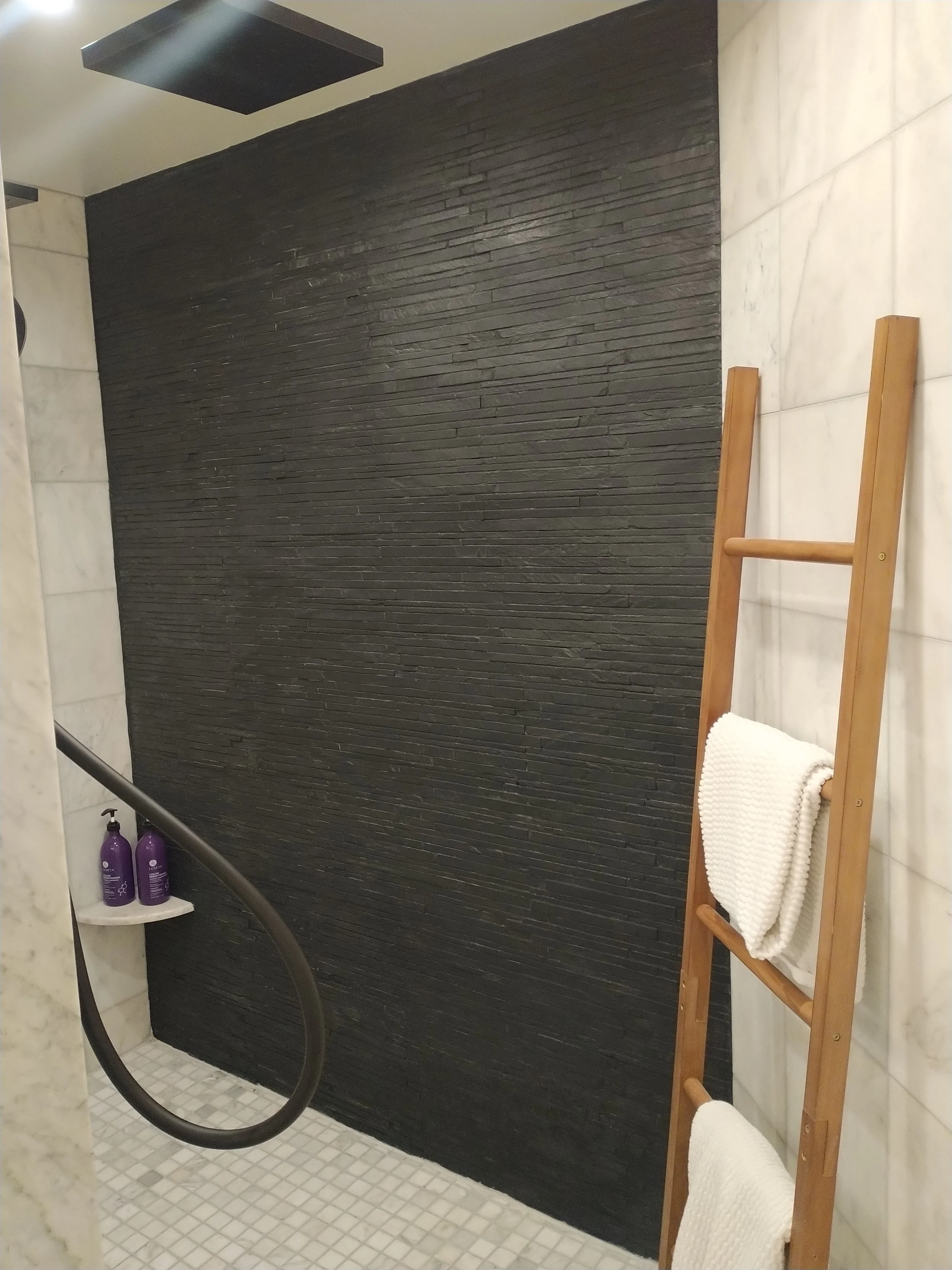 Sophisticated black and white pattern floor tiling. Expert craftsmanship for modern bathroom surfaces in Ellicott City.