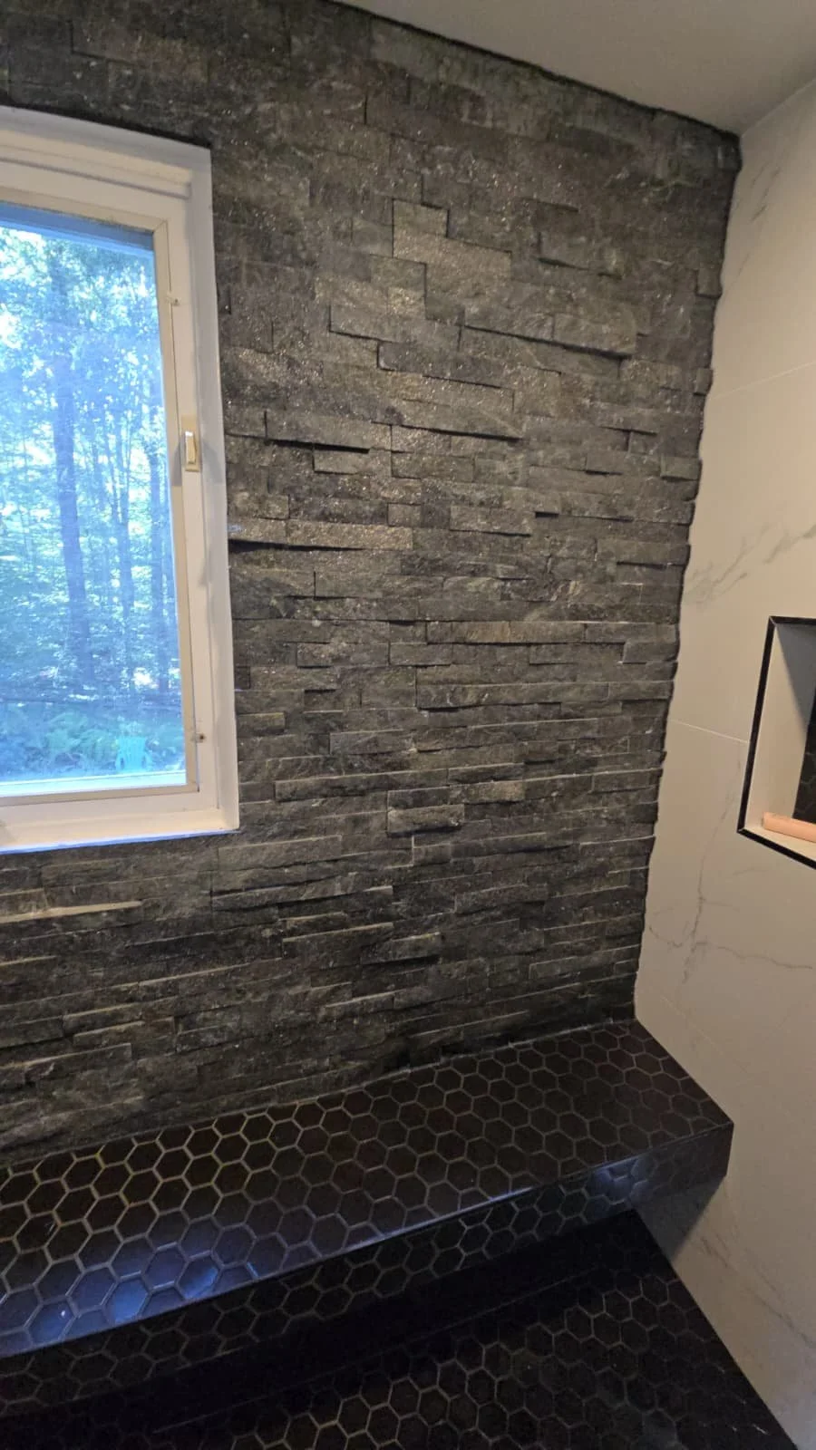 Precision hexagonal tile work and custom shower niche. Artistic bathroom tiling and functional design in Chevy Chase.