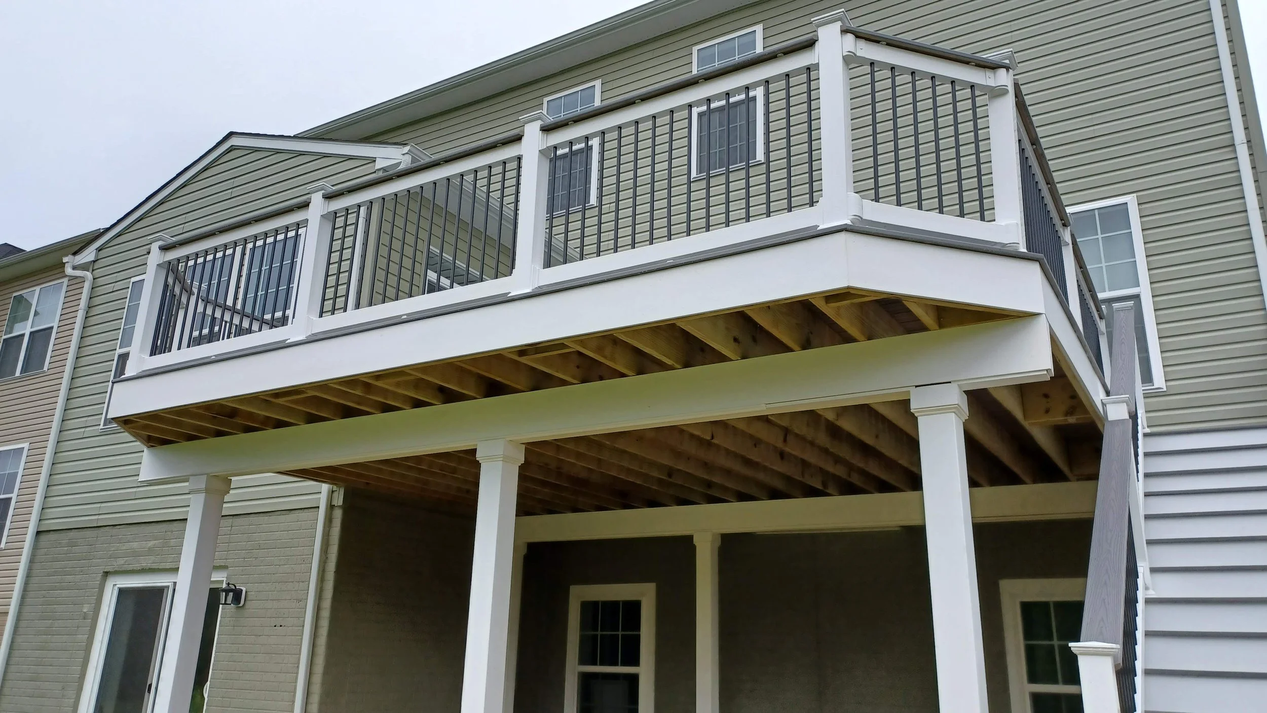 Structural elevated deck framing with pressure-treated lumber. Expert outdoor construction in Point Pleasant Beach, NJ. Custom wood deck construction project in Middletown. High-quality pressure-treated lumber and professional framing. Custom Deck, R