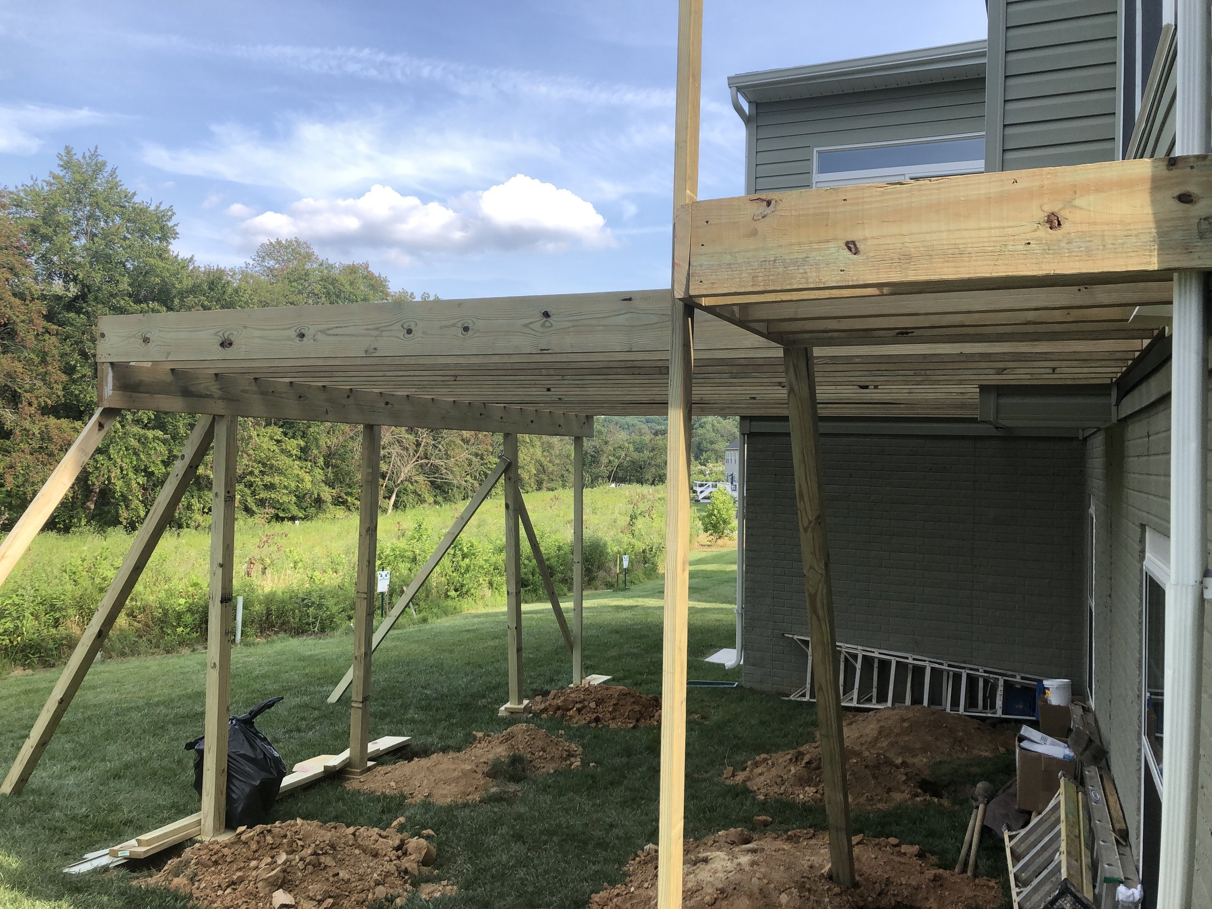 Structural elevated deck framing with pressure-treated lumber. Expert outdoor construction in Point Pleasant Beach, NJ. Custom wood deck construction project in Middletown. High-quality pressure-treated lumber and professional framing. Custom Deck, R