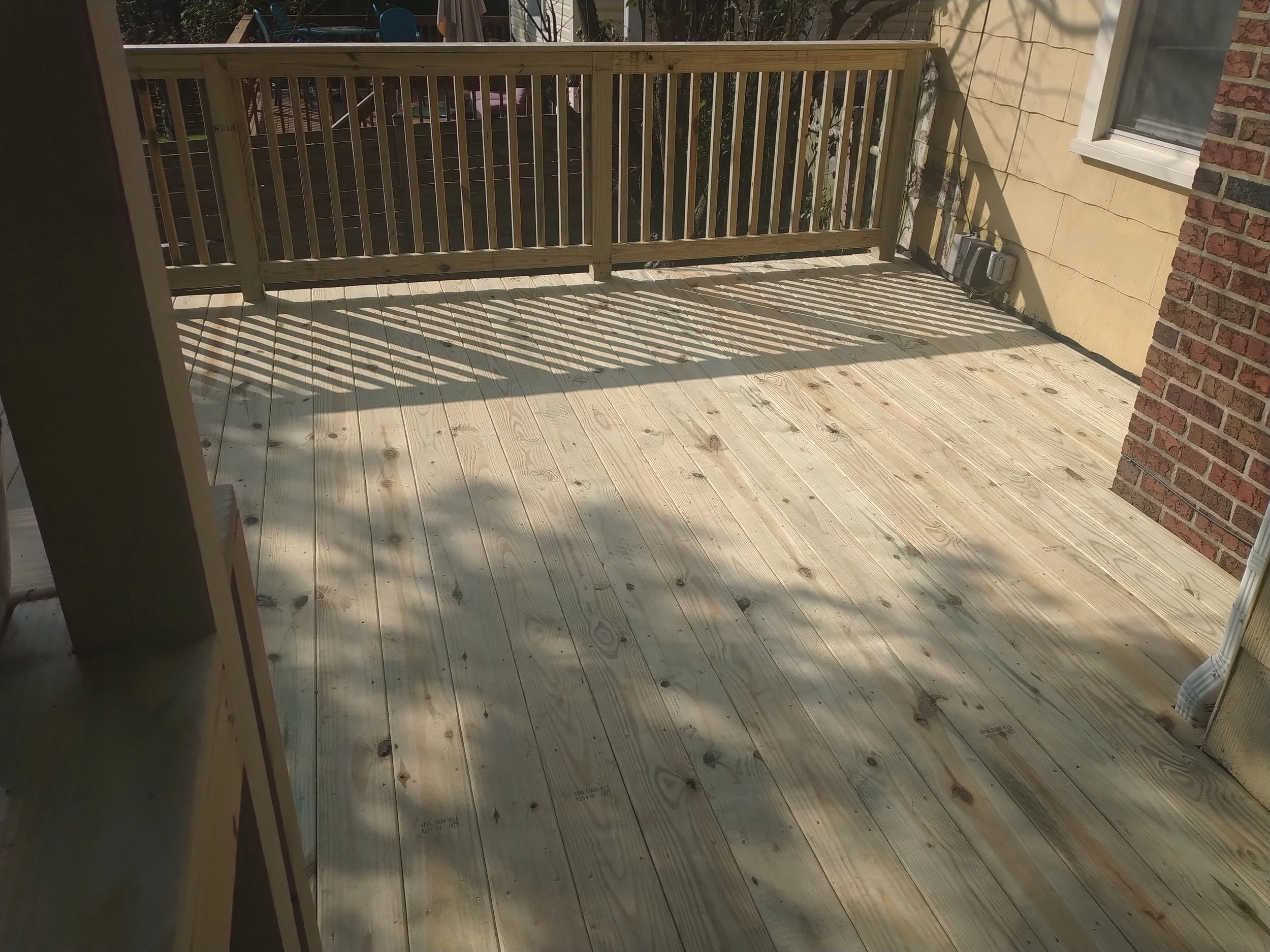 Structural elevated deck framing with pressure-treated lumber. Expert outdoor construction in Point Pleasant Beach, NJ. Custom wood deck construction project in Middletown. High-quality pressure-treated lumber and professional framing. Custom Deck, R