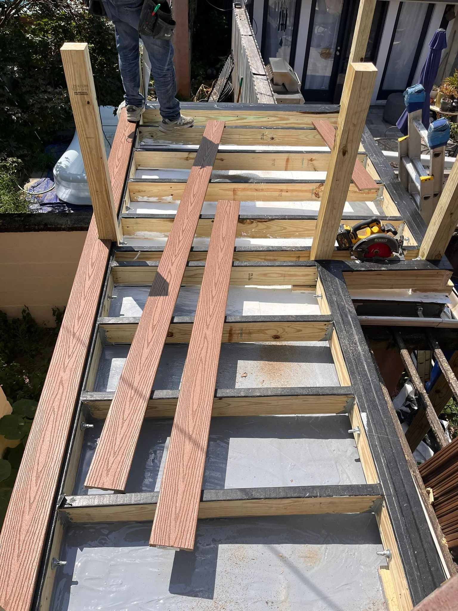 Custom wood deck construction project in Middletown. High-quality pressure-treated lumber and professional framing. Custom Deck, Roof Deck, Vinyl Hand rails, composite boards, door deck, deck builder, deck engineering, deck builder in NYC, deck build