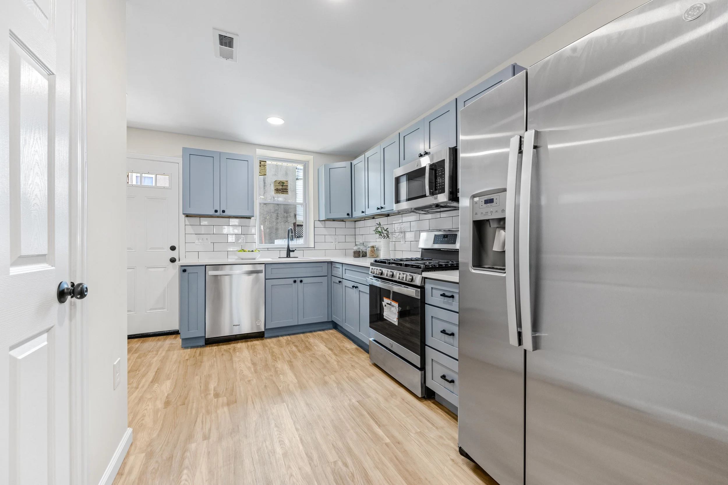 Modern Kitchen Remodel with Blue Cabinets and Stainless Steel Appliances