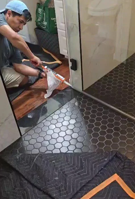 Custom glass shower enclosure with premium tile work. Professional bathroom renovation for luxury residences in Chevy Chase, MD.