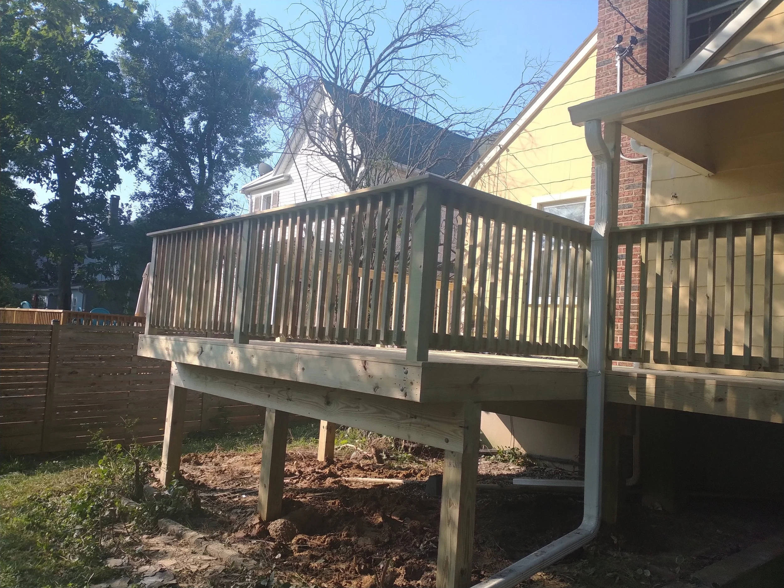 Structural elevated deck framing with pressure-treated lumber. Expert outdoor construction in Point Pleasant Beach, NJ. Custom wood deck construction project in Middletown. High-quality pressure-treated lumber and professional framing. Custom Deck, R