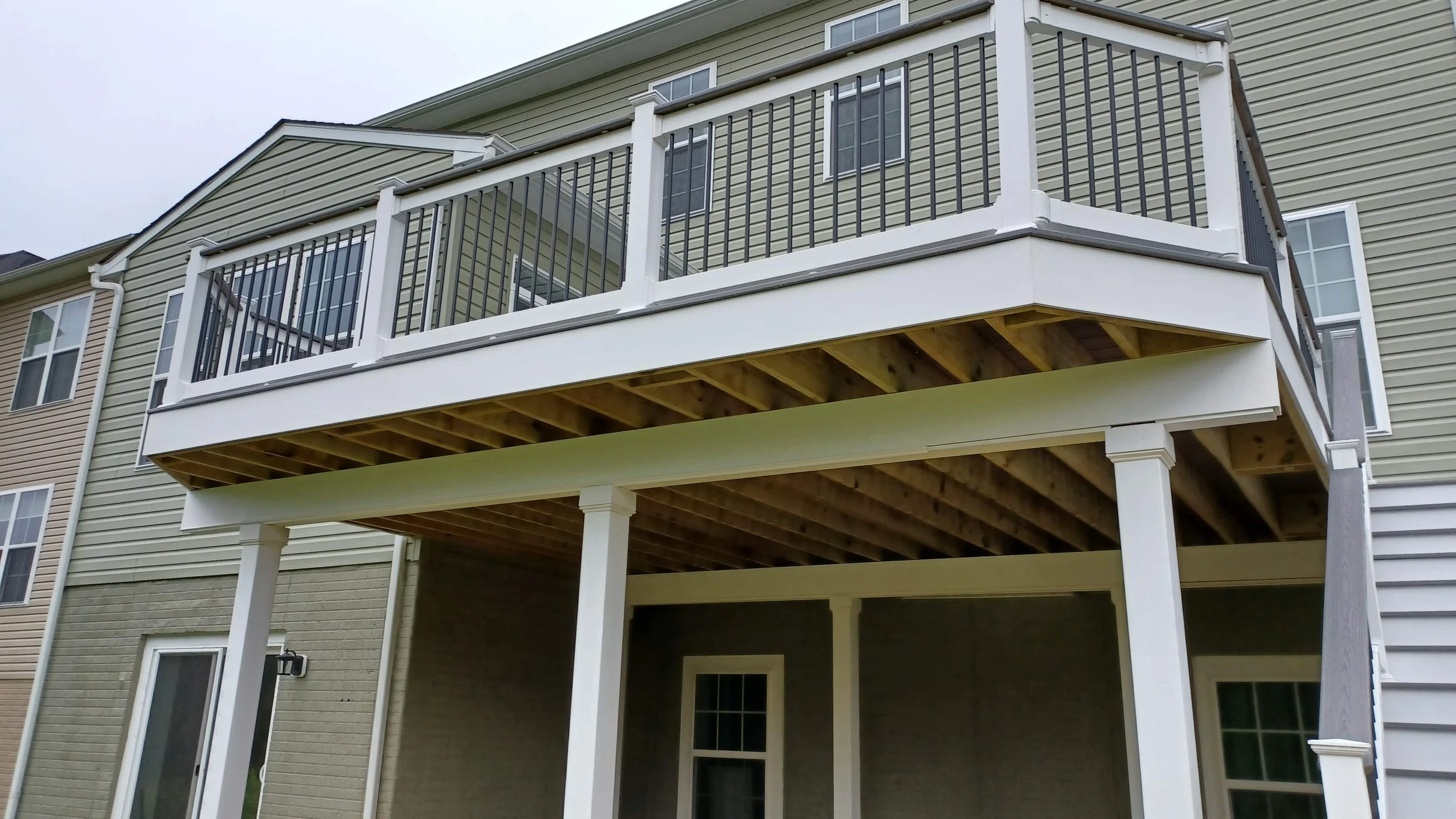 Structural elevated deck framing with pressure-treated lumber. Expert outdoor construction in Point Pleasant Beach, NJ. Custom wood deck construction project in Middletown. High-quality pressure-treated lumber and professional framing. Custom Deck, R