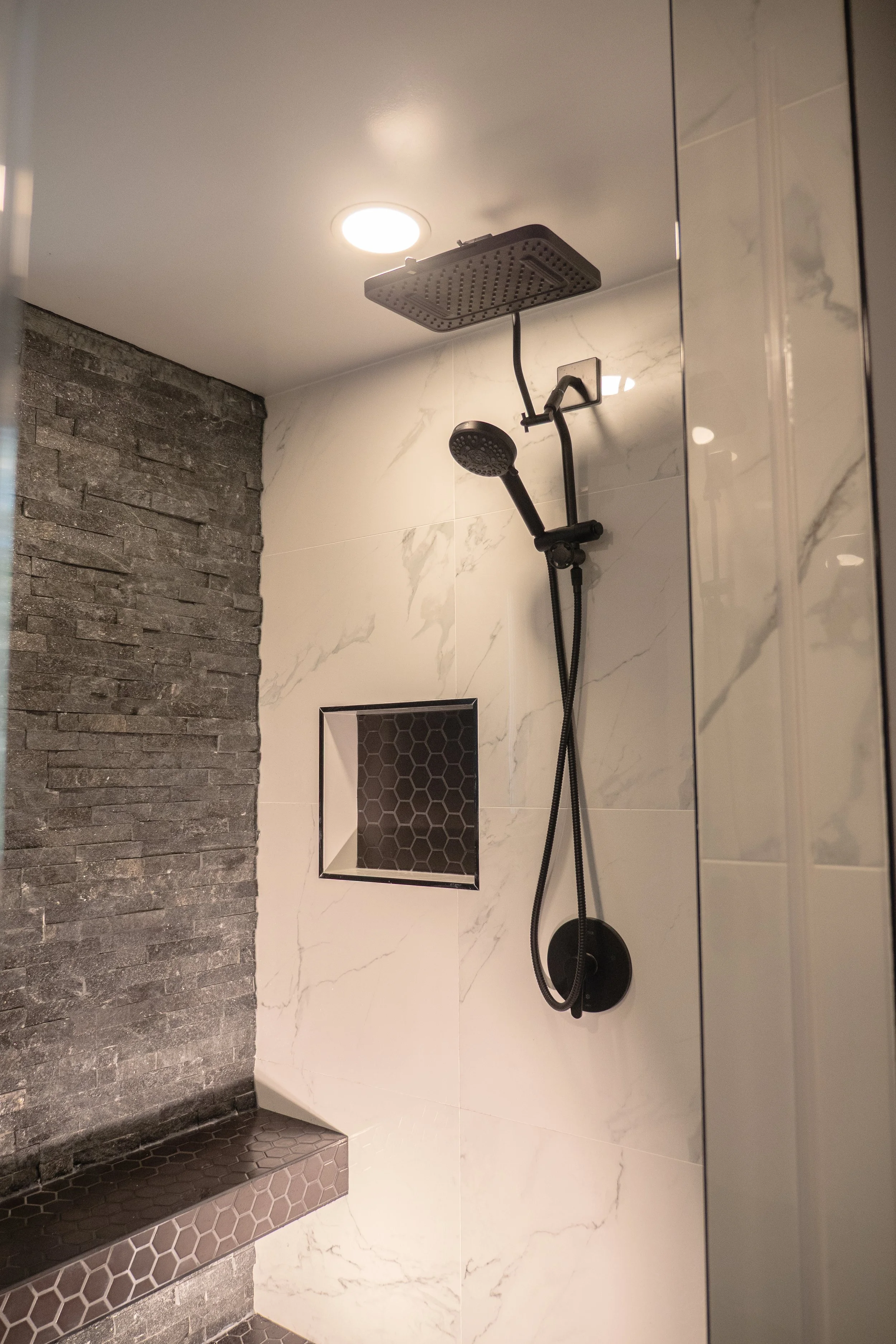 Matching matte black bathroom hardware and accessory set. Attention to detail in luxury home remodeling in Bethesda.