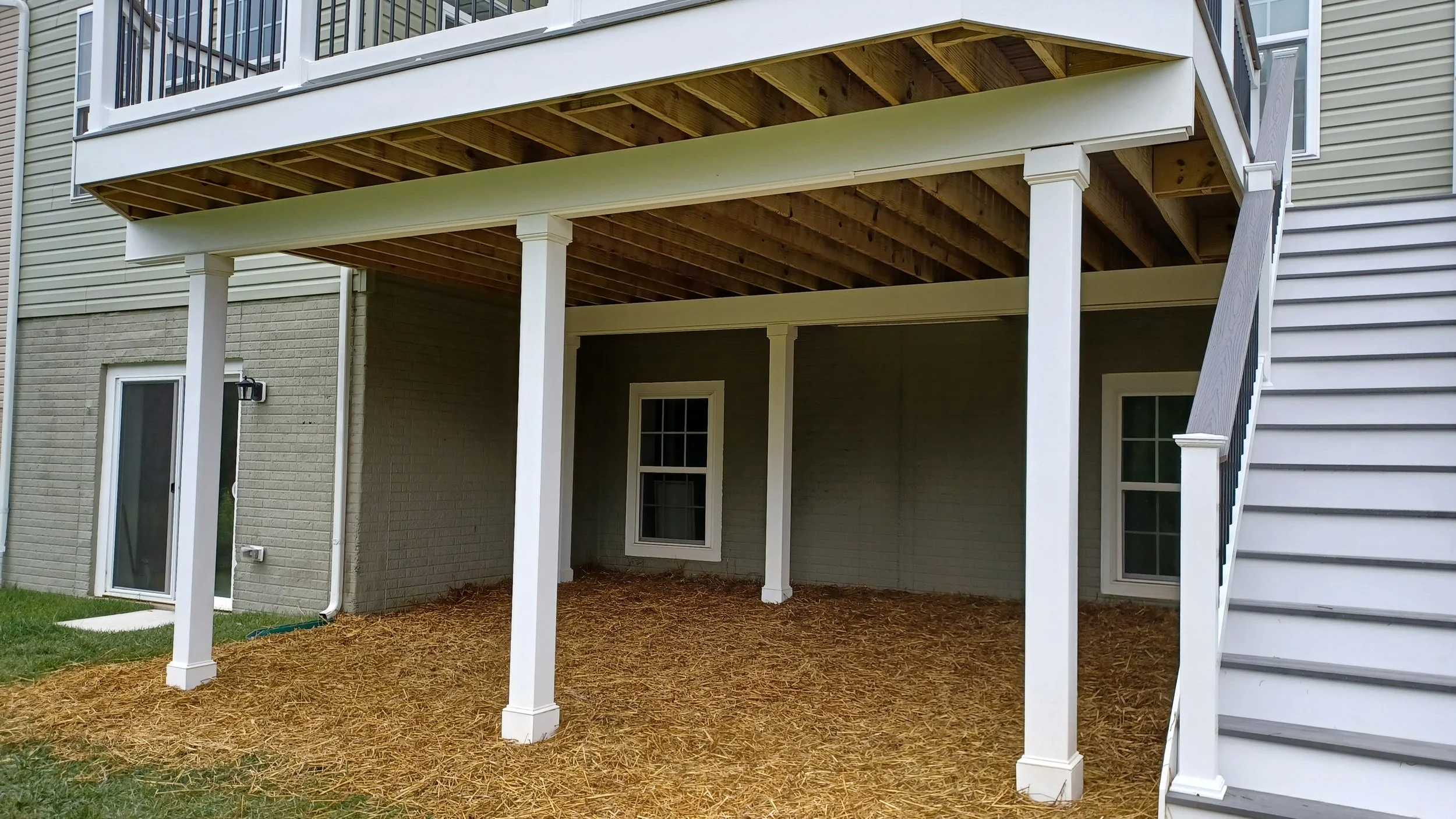 Structural elevated deck framing with pressure-treated lumber. Expert outdoor construction in Point Pleasant Beach, NJ. Custom wood deck construction project in Middletown. High-quality pressure-treated lumber and professional framing. Custom Deck, R