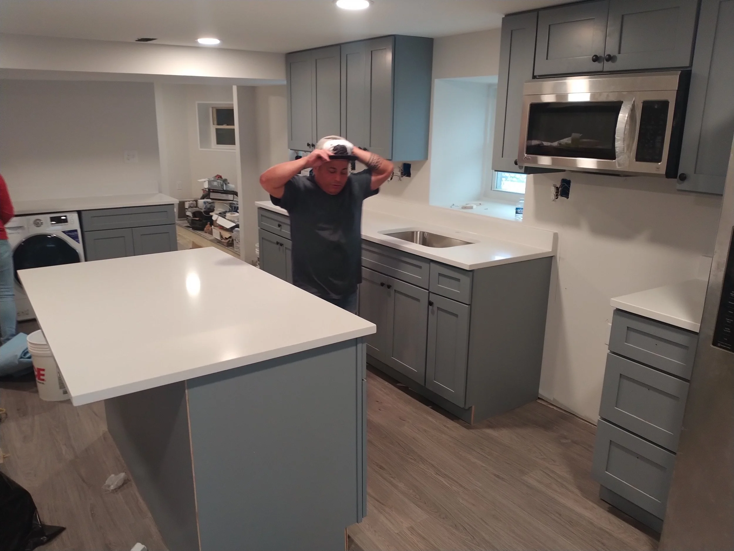 Innovative integrated kitchen and laundry suite in Red Bank, NJ. Smart space optimization and high-end design for modern living by Elite Craft.