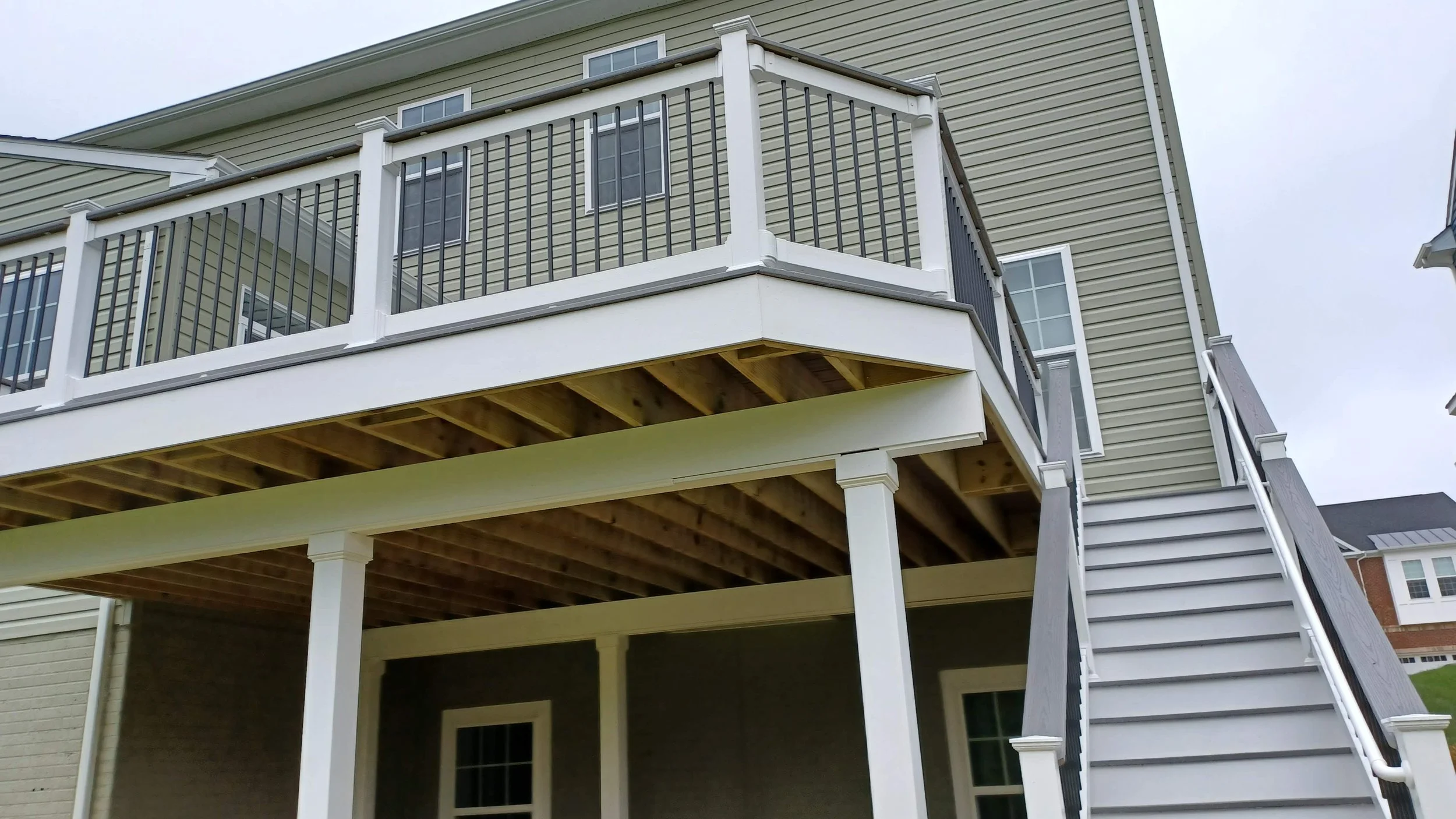 Structural elevated deck framing with pressure-treated lumber. Expert outdoor construction in Point Pleasant Beach, NJ. Custom wood deck construction project in Middletown. High-quality pressure-treated lumber and professional framing. Custom Deck, R