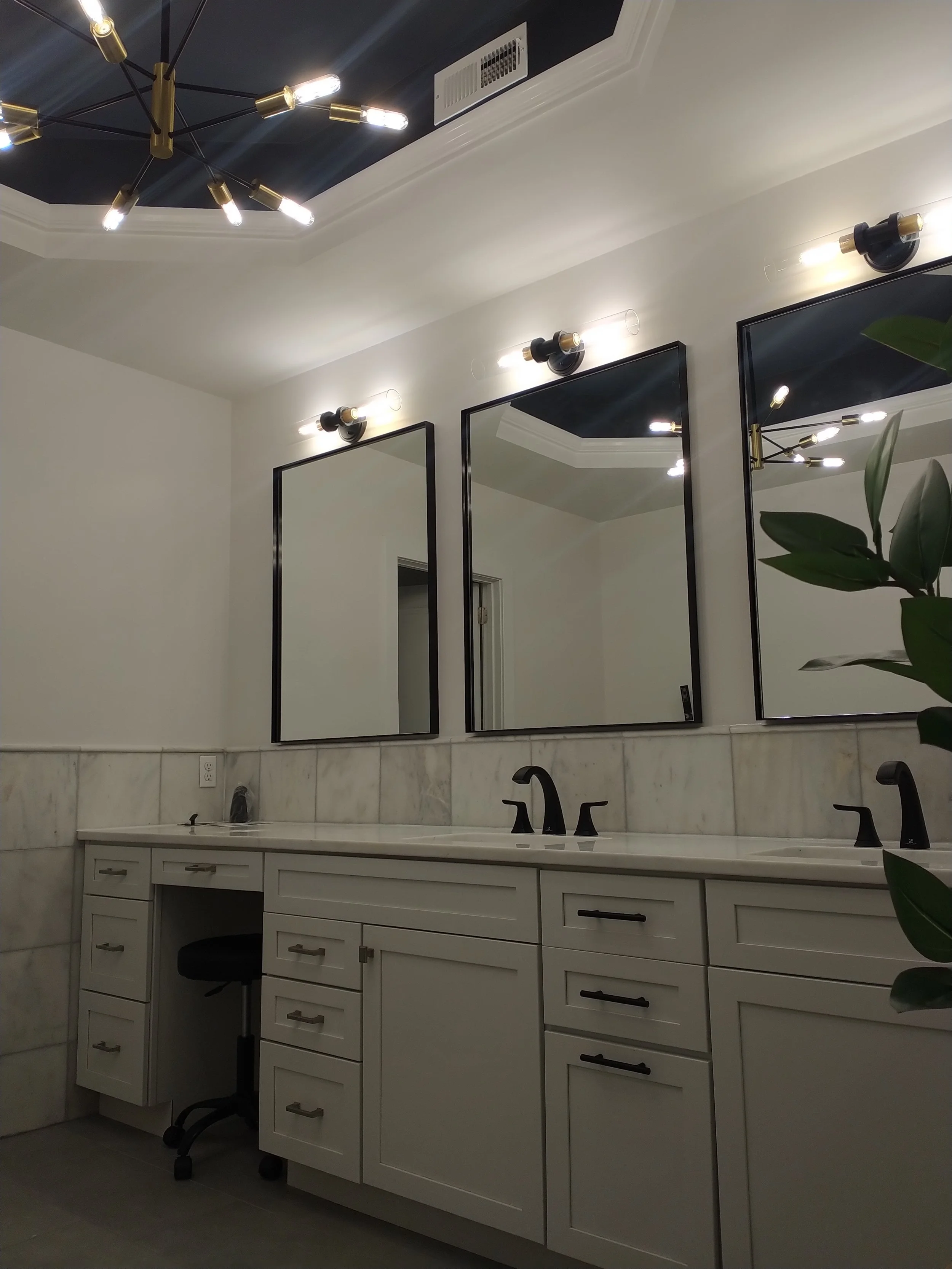 Custom modern bathroom vanity with dual circular mirrors. High-end cabinetry and elegant lighting design in Ellicott City, Maryland.