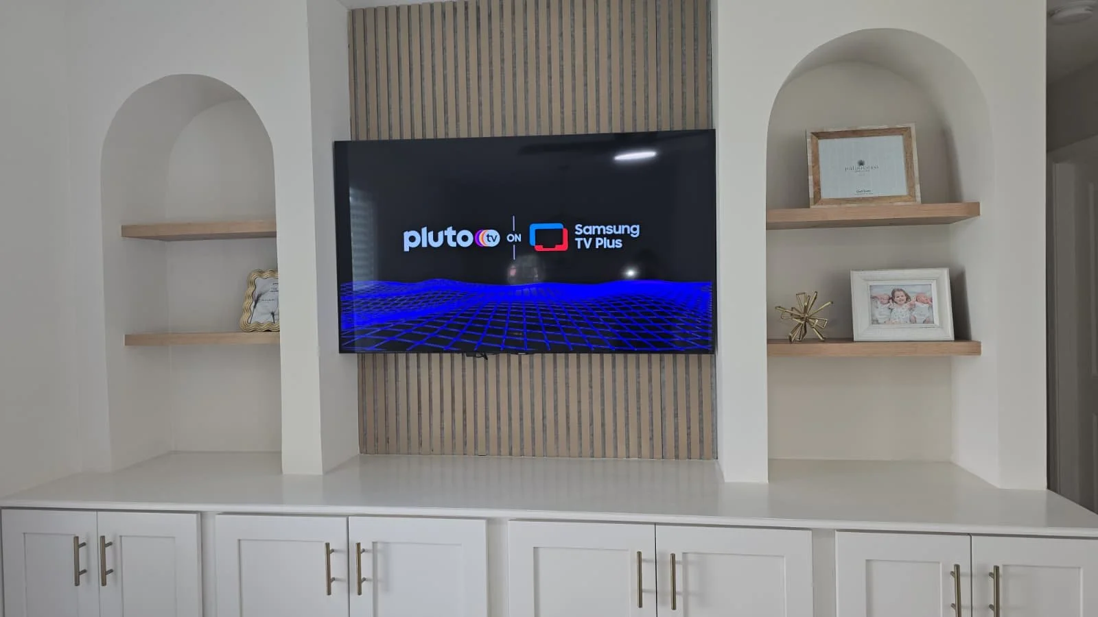 Integrated entertainment center with custom wood shelving. Seamless design for contemporary living rooms in Bethesda, MD.