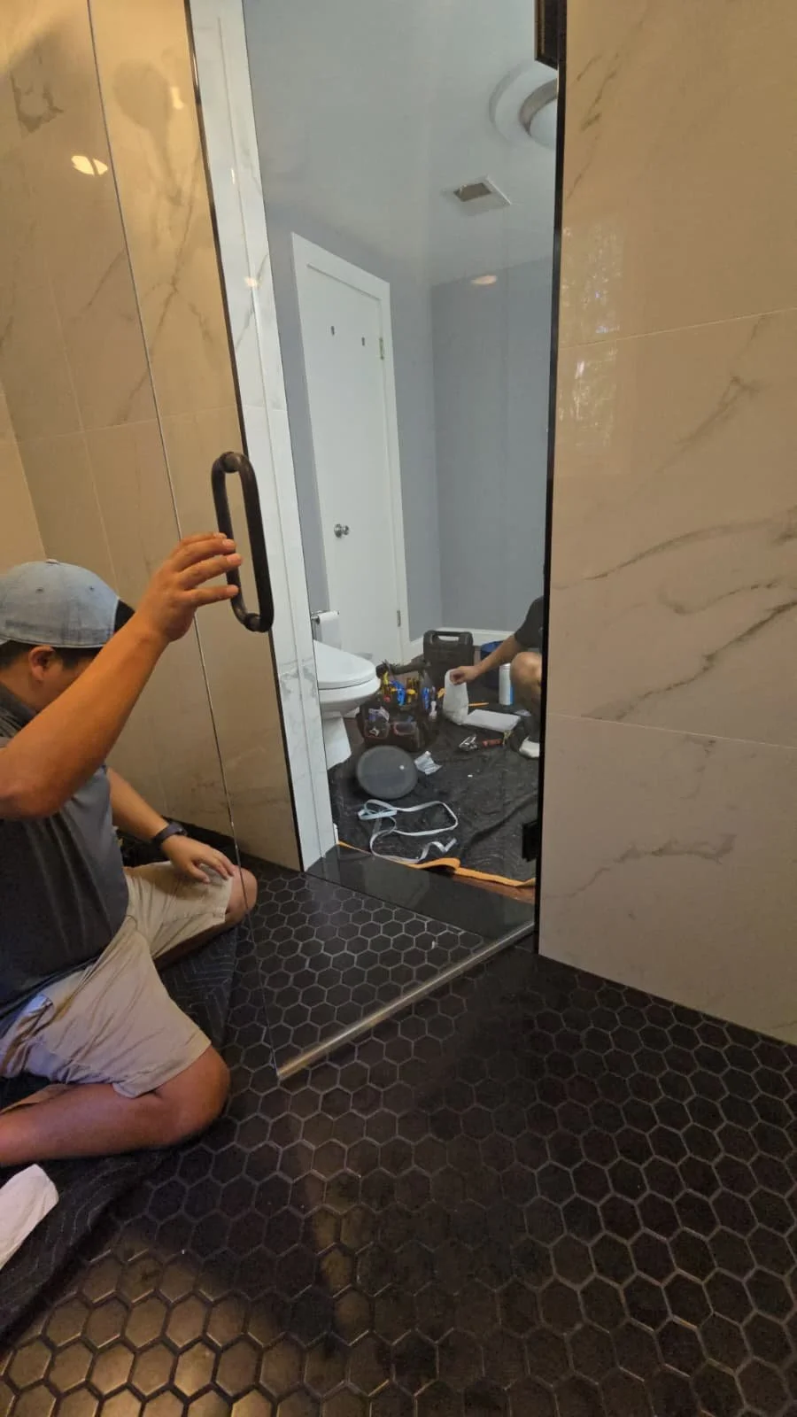 Modern matte black rainfall shower system installation. Upscale bathroom hardware and fixture upgrades in Bethesda, MD.