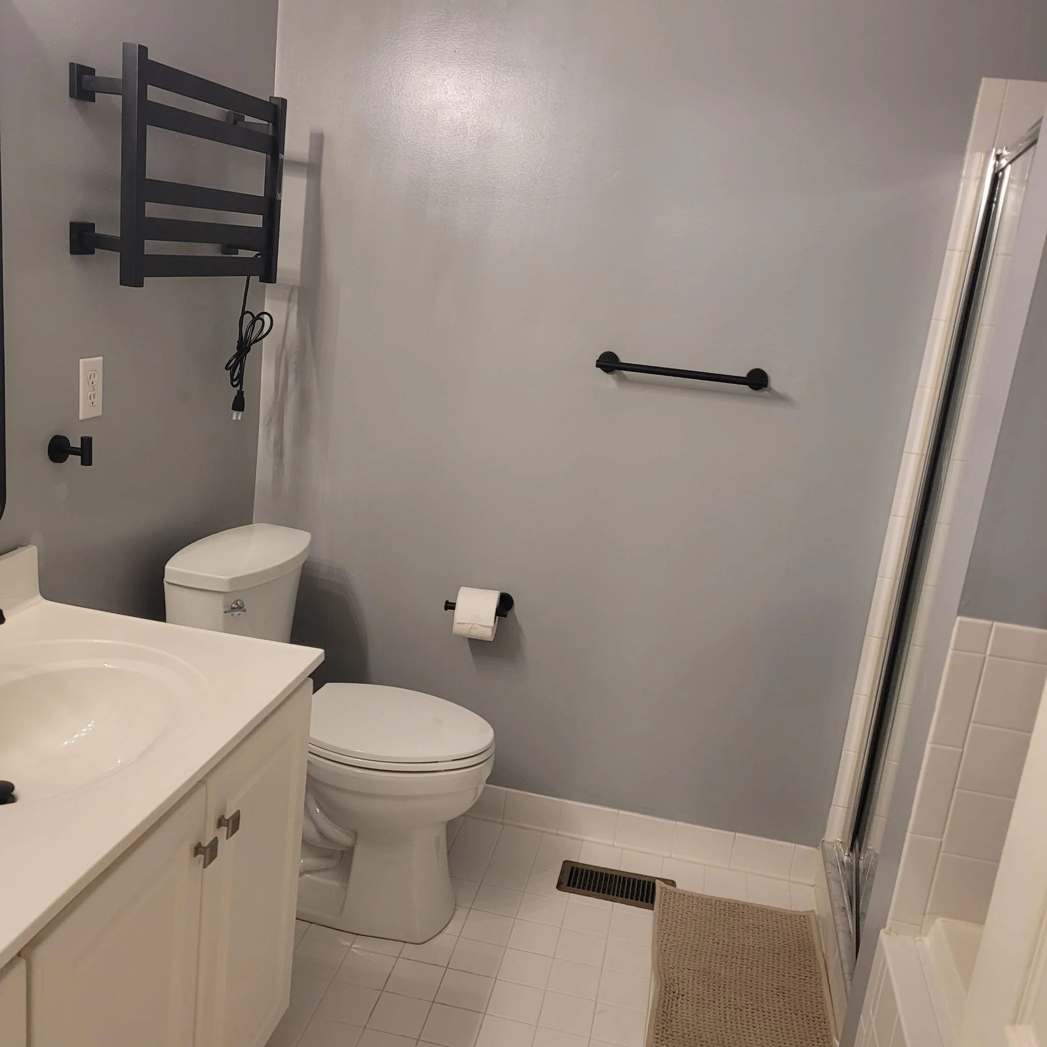 Modern matte black rainfall shower system installation. Upscale plumbing hardware and fixtures in Long Branch, NJ.