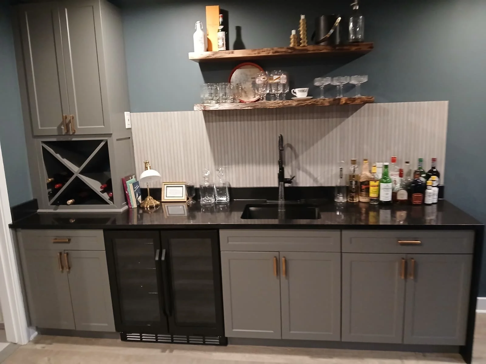 Undermount bar sink installation with premium fixtures. Expert plumbing and countertop integration in Columbia, Maryland.
Custom Bar & Cabinetry Installation – Interior Renovation

This project features a fully custom-built bar and cabinetry installa