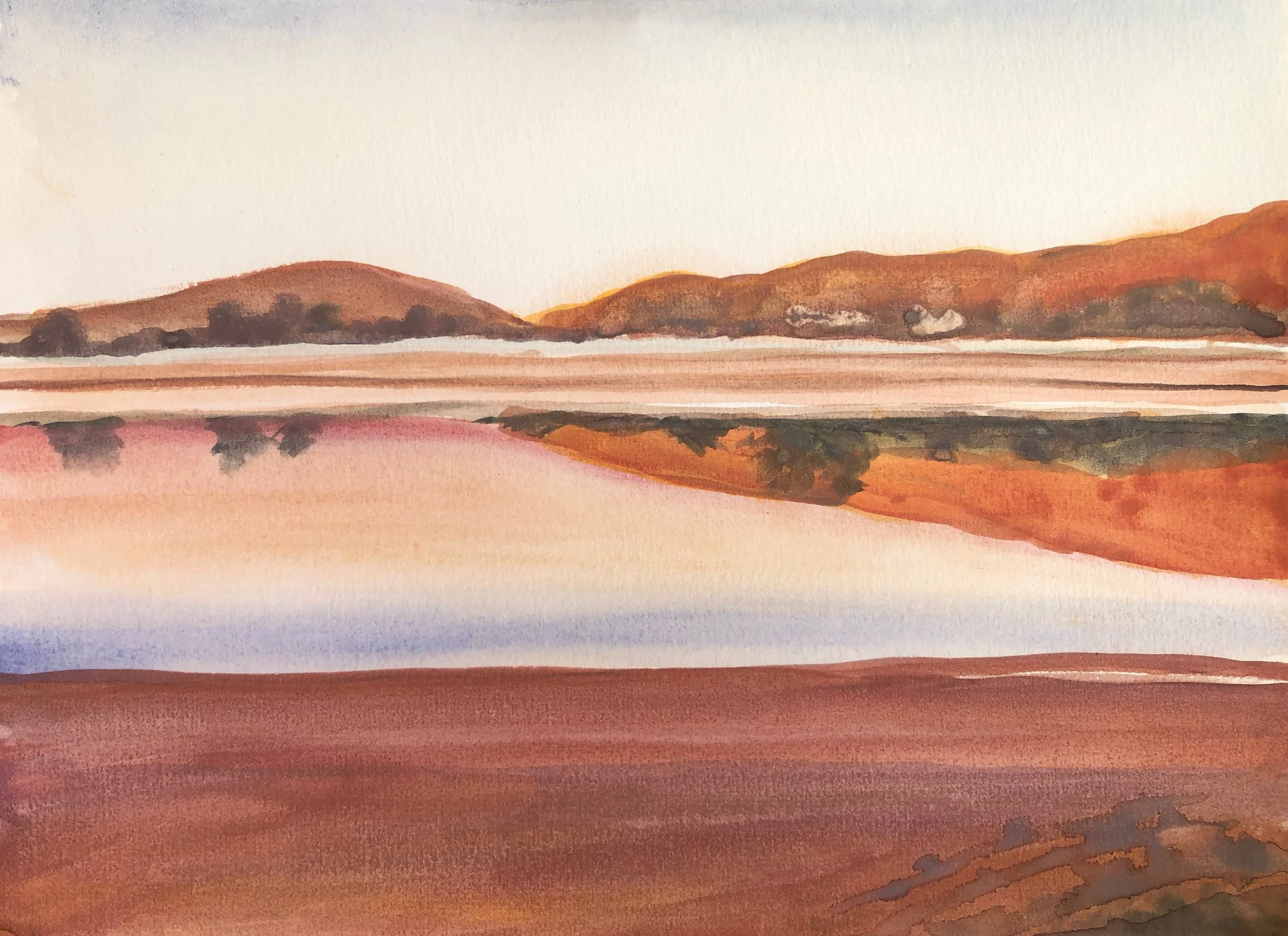 A watercolor painting of a landscape featuring calm water, rolling hills in shades of brown and orange, and a clear sky.